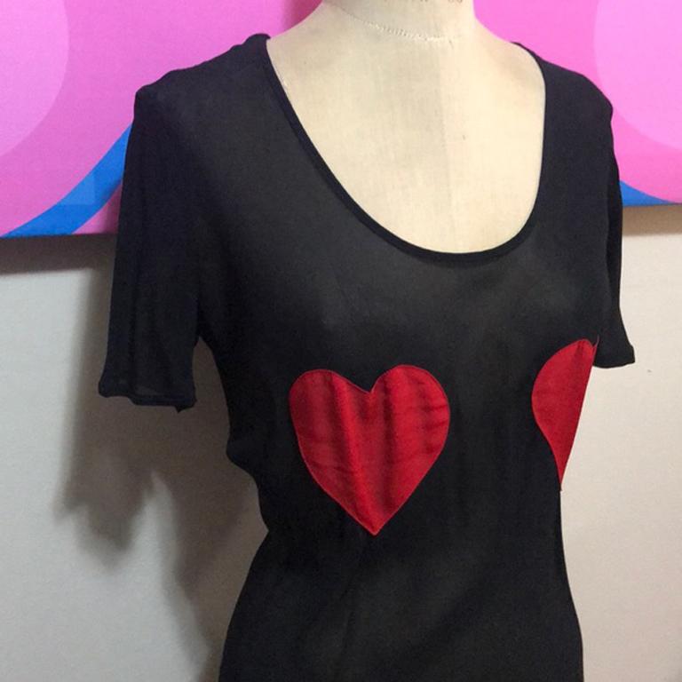 Moschino pret-a-porter black red heart blouse top

Unique vintage Moschino blouse with red Hearts at the chest area - seems to be bias cut.  Pair with black skinny pants and heels for a date night look!
Please check measurements to ensure
