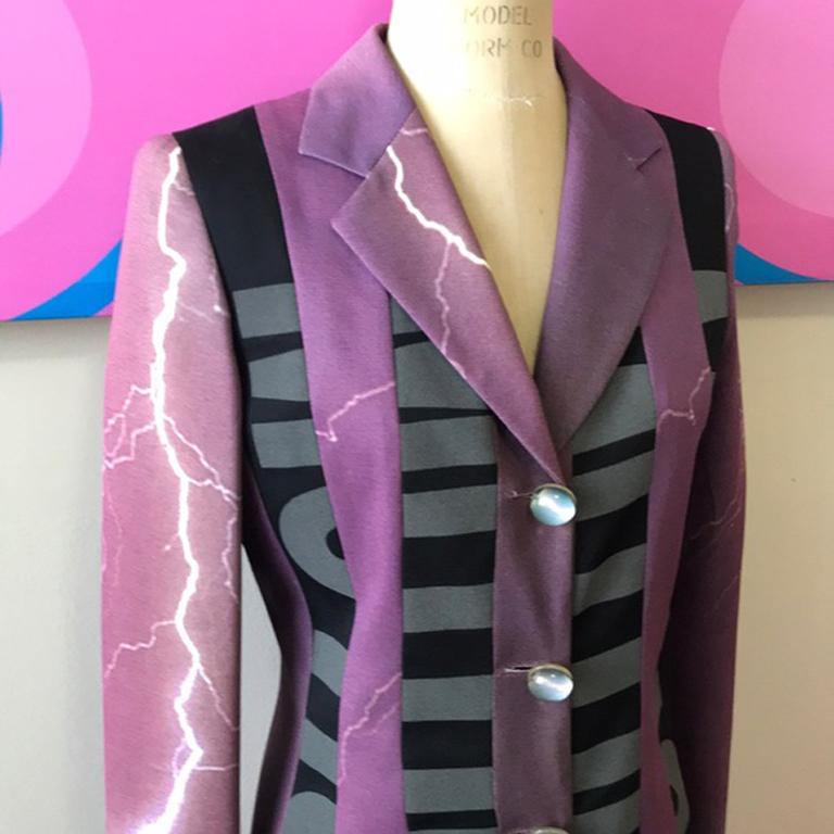 Moschino purple energy lightening bolt blazer

Be retro cool in this vintage blazer from Moschino Cheap and Chic. Pair with black skinny Pants and boots for a great look. 
Condition: Slight discoloration at inside lining at armpits. Some pricks in