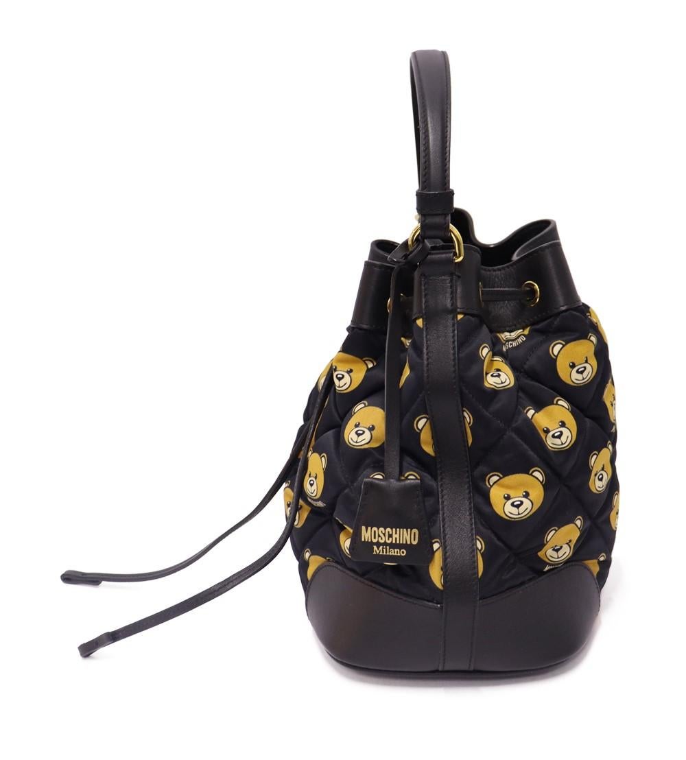 Moschino Quilted Small Teddy Bear Bucket Bag, Features single top handle, satin lining, interior pockets; one with zip closure and one slip pocket.

Material: Leather
Hardware: Gold
Height: 25.5cm
Width: 25.5cm
Depth: 17cm
Handle Drop: