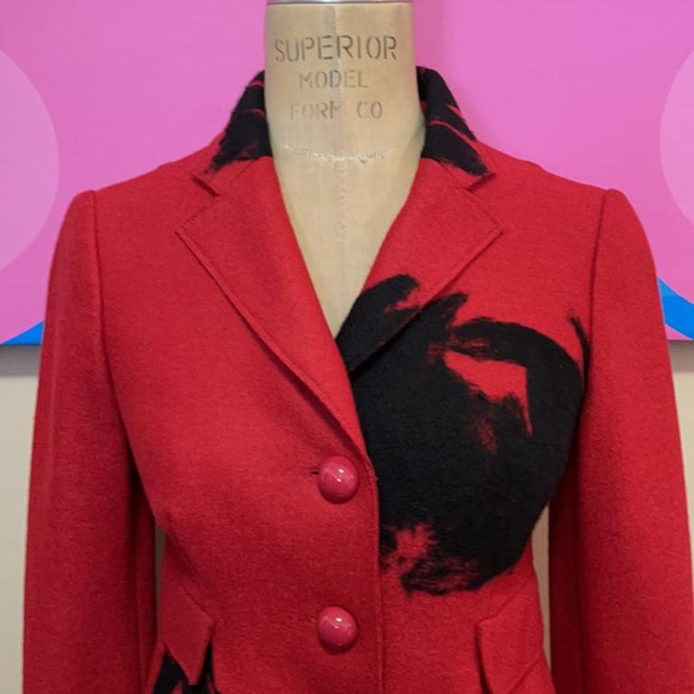 Moschino red black wool riding jacket

This vintage riding style jacket by Moschino Cheap & Chic has a super cute black flower design. Pair with skinny pants and boots or a pencil skirt for a finished look. 
Size 4

Across chest - 16.5 in.
Across