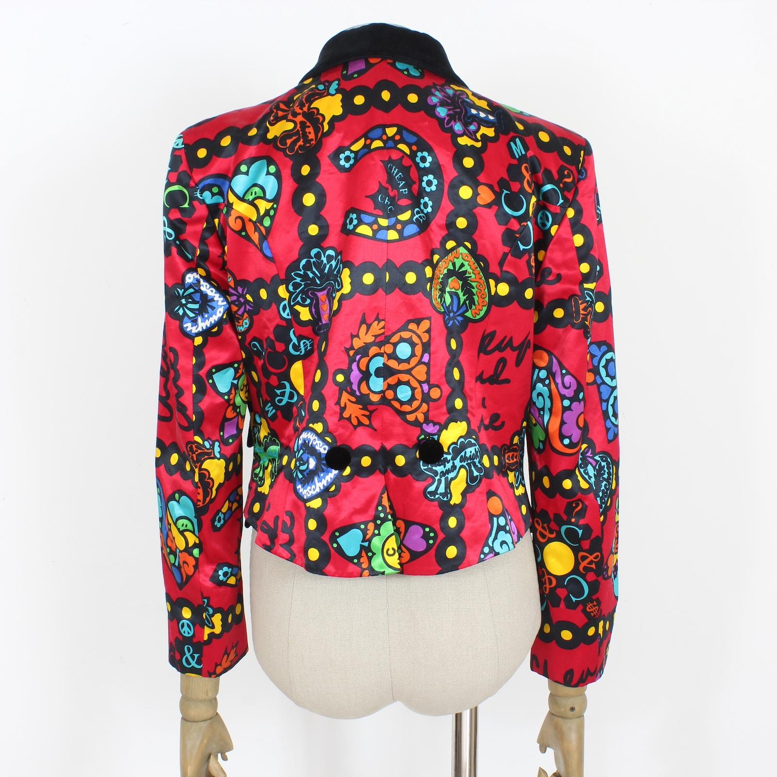 Capture the essence of the 1990s with this iconic Franco Moschino design. This blazer jacket features playful messages and bold symbols such as peace signs, hearts, bows, and dollar signs. Its fabric for 58% cotton and rayon for 42 % has a satin