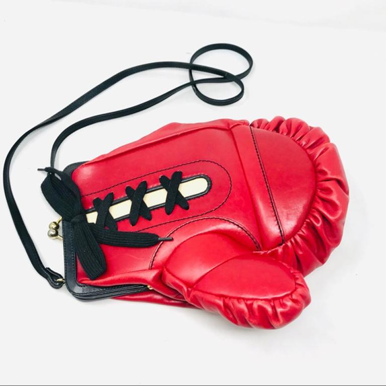 Moschino red leather boxing glove bag purse

This vintage boxing glove bag is a unique addition to your wardrobe! Perfect for showing your sense of humor for special events. From 1991 Season. This has obvious signs of wear including two black lines
