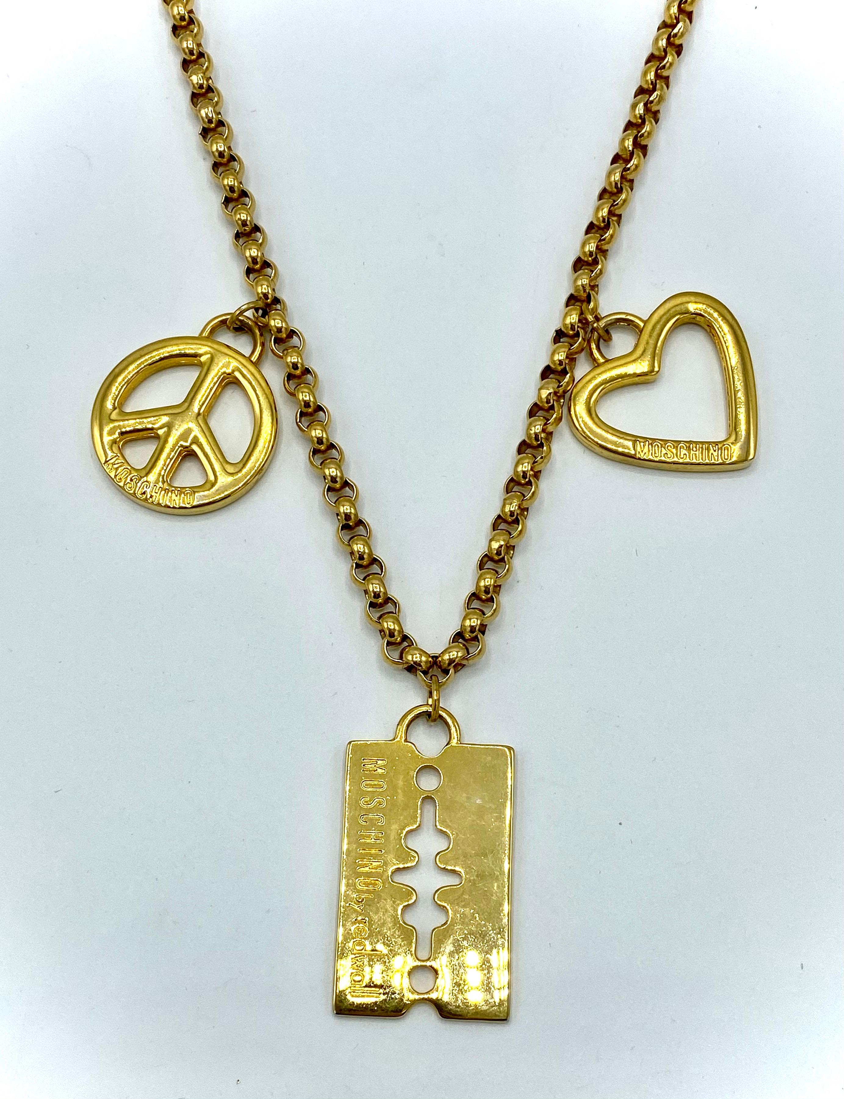 Chic Moschino by Redwall charm necklace from the 1990s. Gold plate chain and charms and made in Italy. The chain is a Belcher style and measures .25 of an inch in diameter. The necklace is 24 inches long including the claw clasp. Each charm is