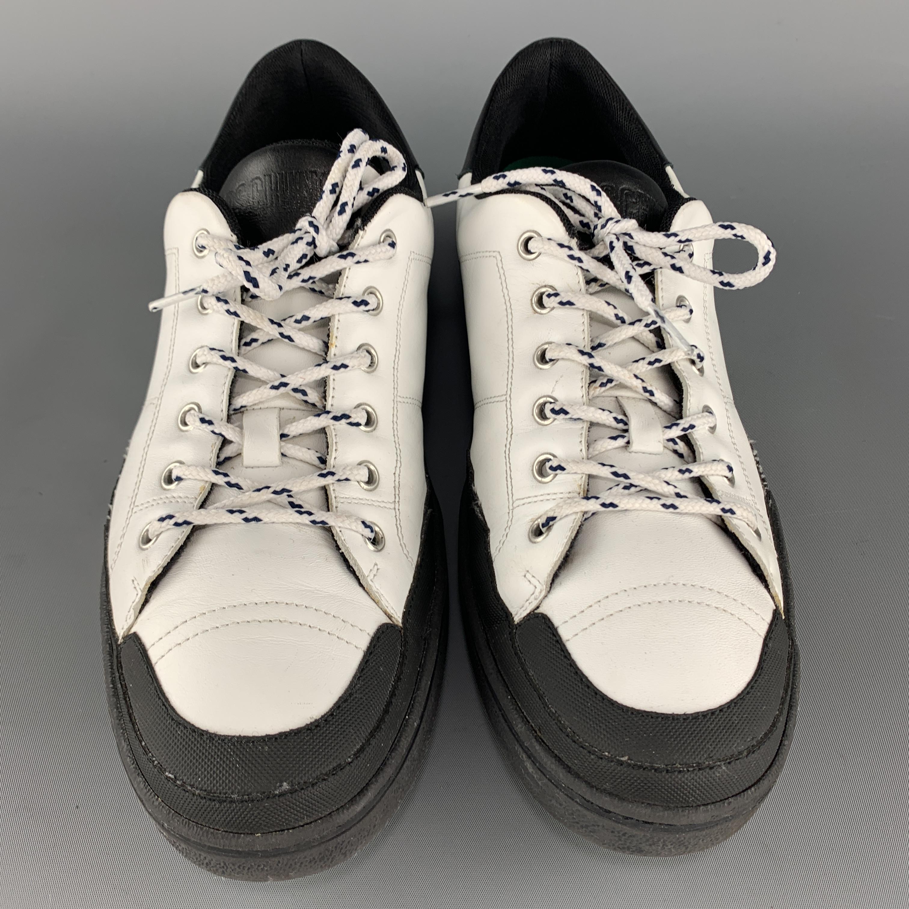 MOSCHINO sneakers come in white leather with a black heel and extended rubber sole with logo. 

Excellent Pre-Owned Condition.
Marked: IT 45

Outsole: 12 x 4 in.
