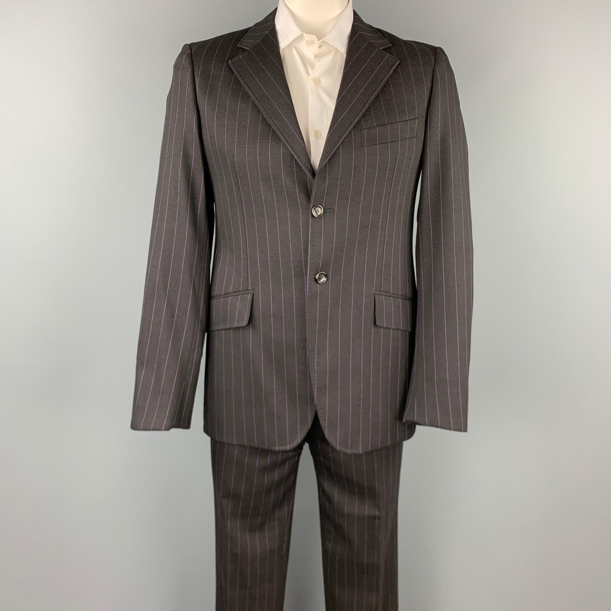 MOSCHINO suit comes in a black stripe wool and includes a single breasted, two button sport coat with a notch lapel and matching flat front trousers. Made in Italy. 

Very Good Pre-Owned Condition.
Marked: IT 52

Measurements:

-Jacket
Shoulder: