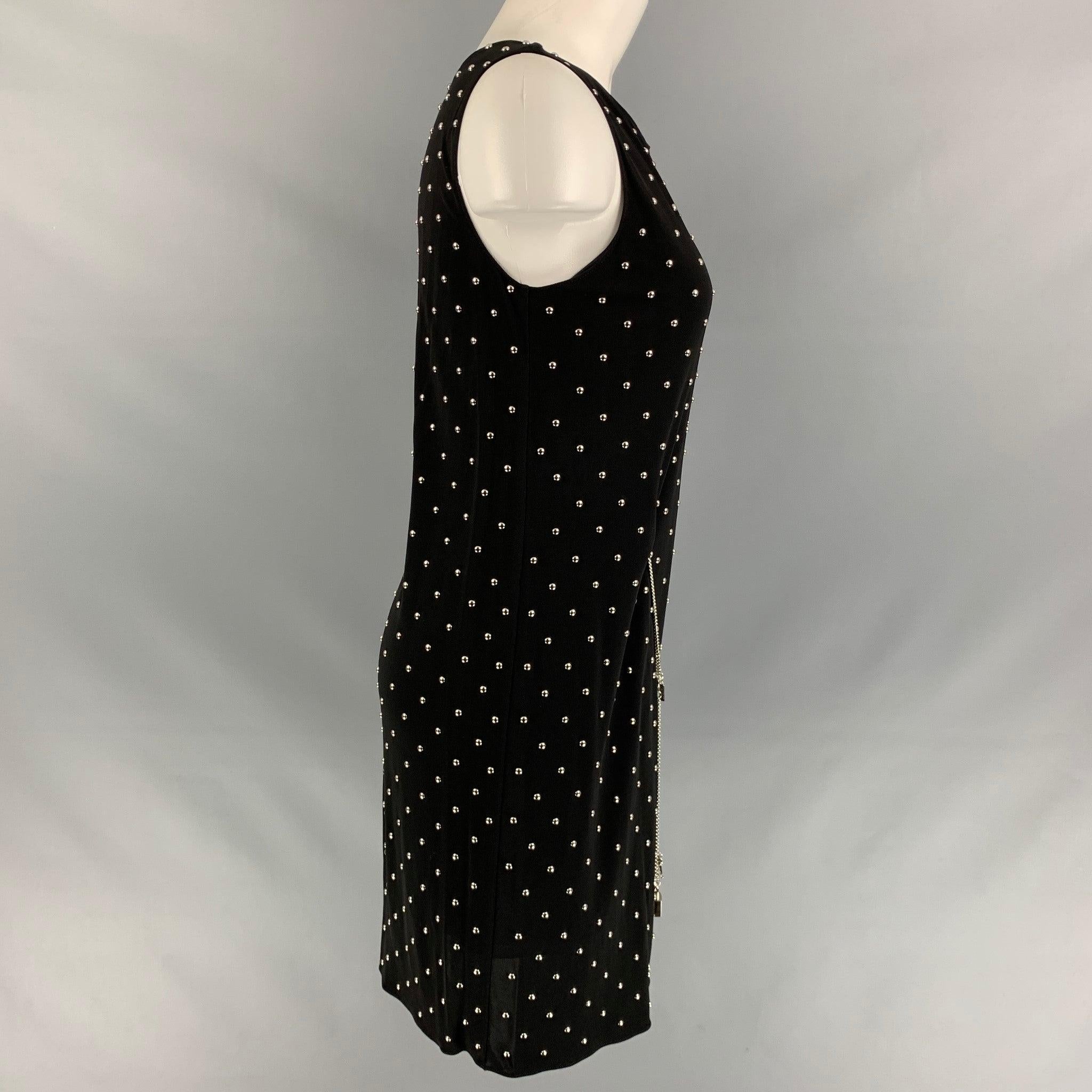 CHEAPANDCHIC by MOSCHINO sleeveless dress in a black polyester
 featuring a studded design and lock & key lariat chain belt. Made in Italy.
Excellent Pre-Owned Condition.  

Marked:   IT 40 

Measurements: 
 
Shoulder: 13 inBust: 36 inWaist: 32