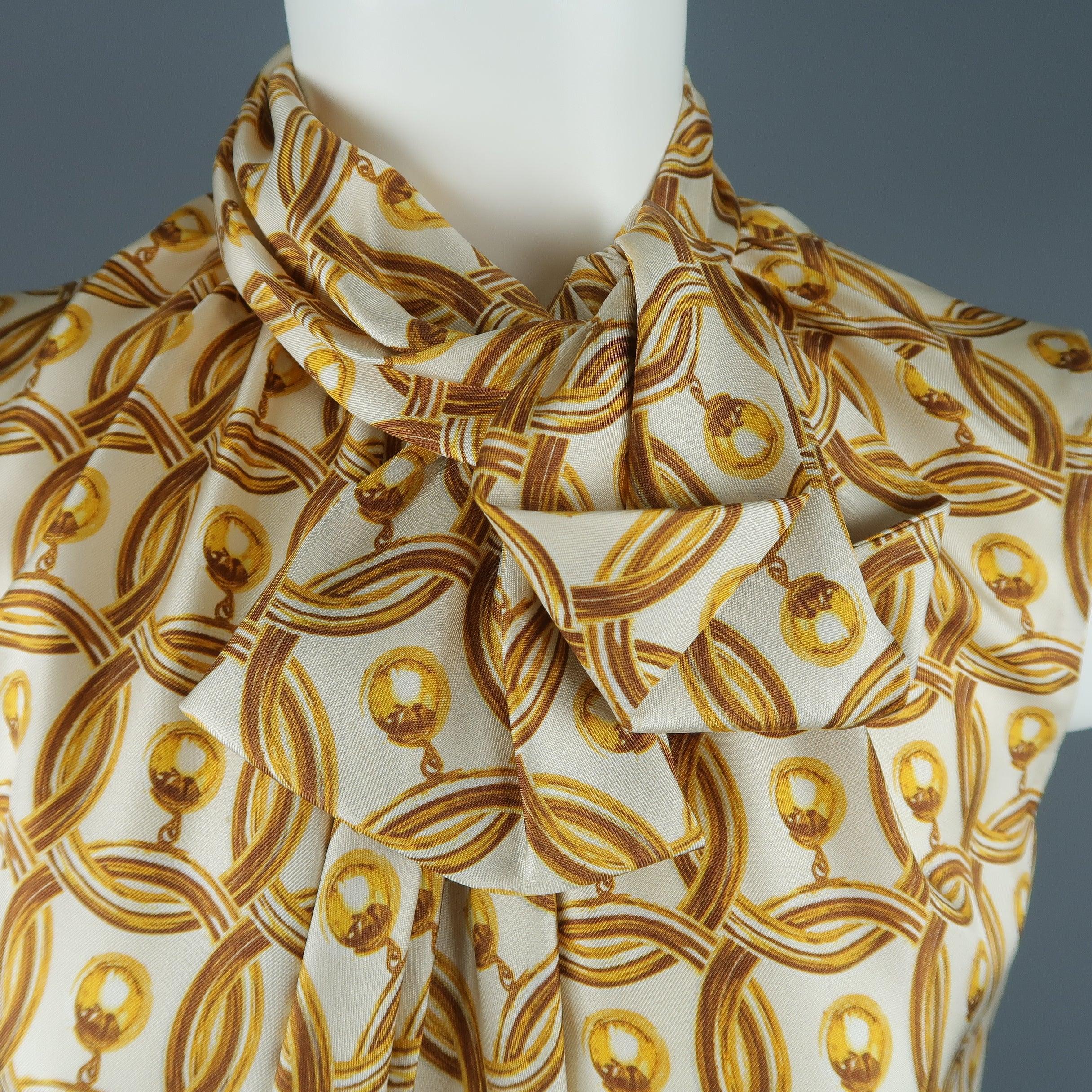 MOSCHINO sleeveless blouse comes in cream silk twill with all over interlocking gold hoop stud earring print and features an A line silhouette and high gathered collar with tie and buttoned back. Made in Italy.
Excellent Pre-Owned Condition.
