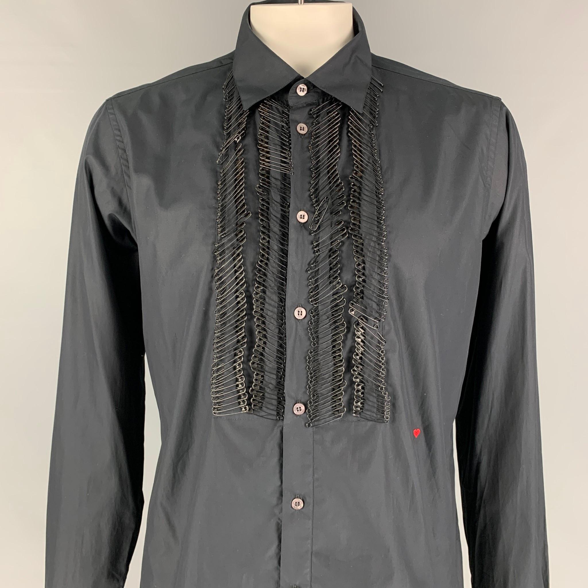 MOSCHINO long sleeve shirt comes in a black cotton featuring a slim fit, safety pin details, embroidered heart detail, spread collar, and a buttoned closure. Made in Italy. 

Excellent Pre-Owned Condition.
Marked: XXL

Measurements:

Shoulder: 19