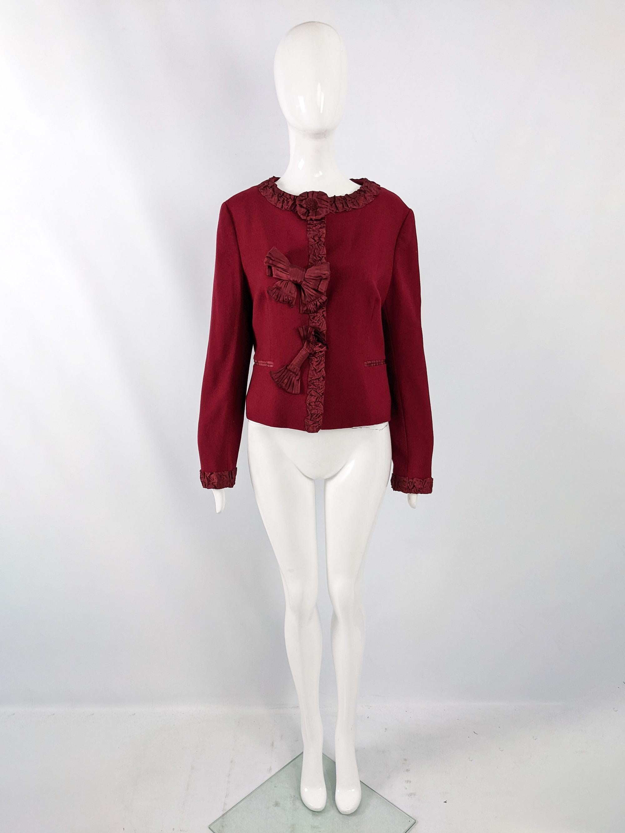 A chic vintage womens Moschino jacket from the late 90s / early 2000s. Made in Italy from a wine red virgin wool crepe fabric with amazing ruched ribbon and bow details to the front, adding a touch of whimsy.

Size: Marked vintage IT 46 but measures