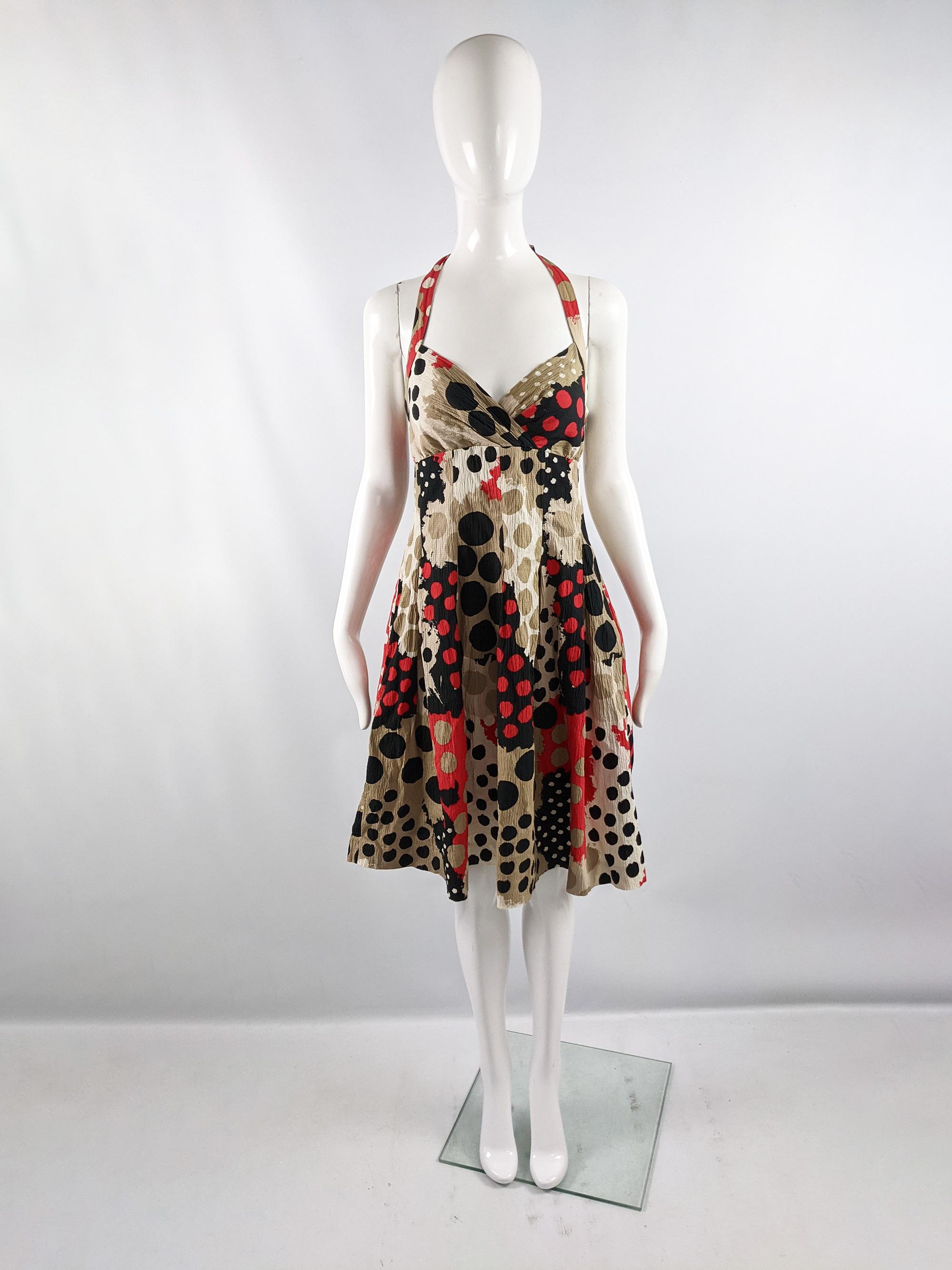 A pretty vintage Moschino dress from the early 2000s. In a crinkled cotton and silk blend with a halter neck and bright red, brown, cream and black abstract polka dot pattern. Perfect for both in the day, in spring and summer, or dressed up at a