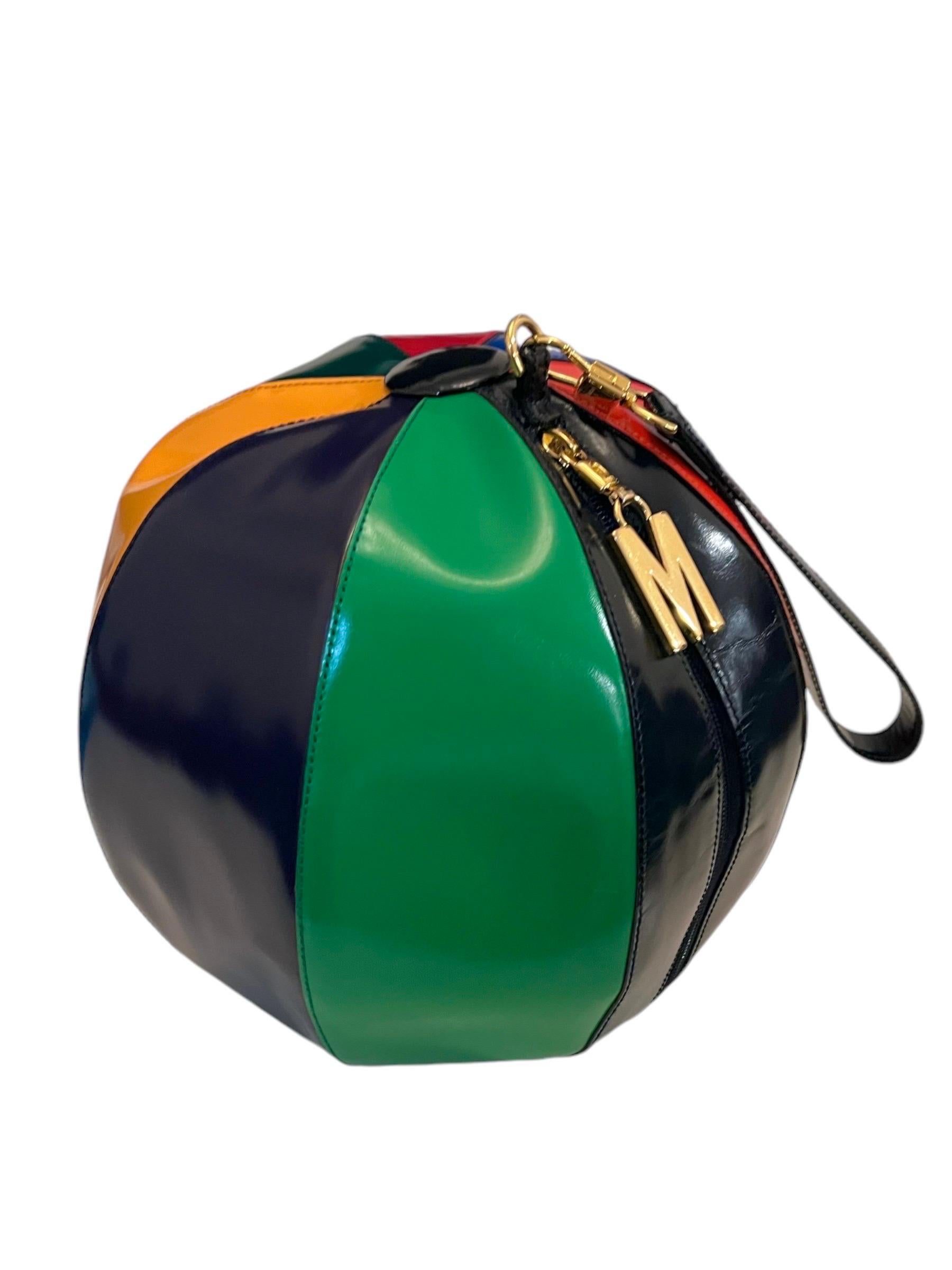 1990's Moschino vintage large beach ball leather wristlet. Features a multicolored pattern with gold tone hardware. 
Zip closure. 
Wrist strap
Interior coin purse zippered pouch attached

Condition: Excellent condition throughout. Light surface wear