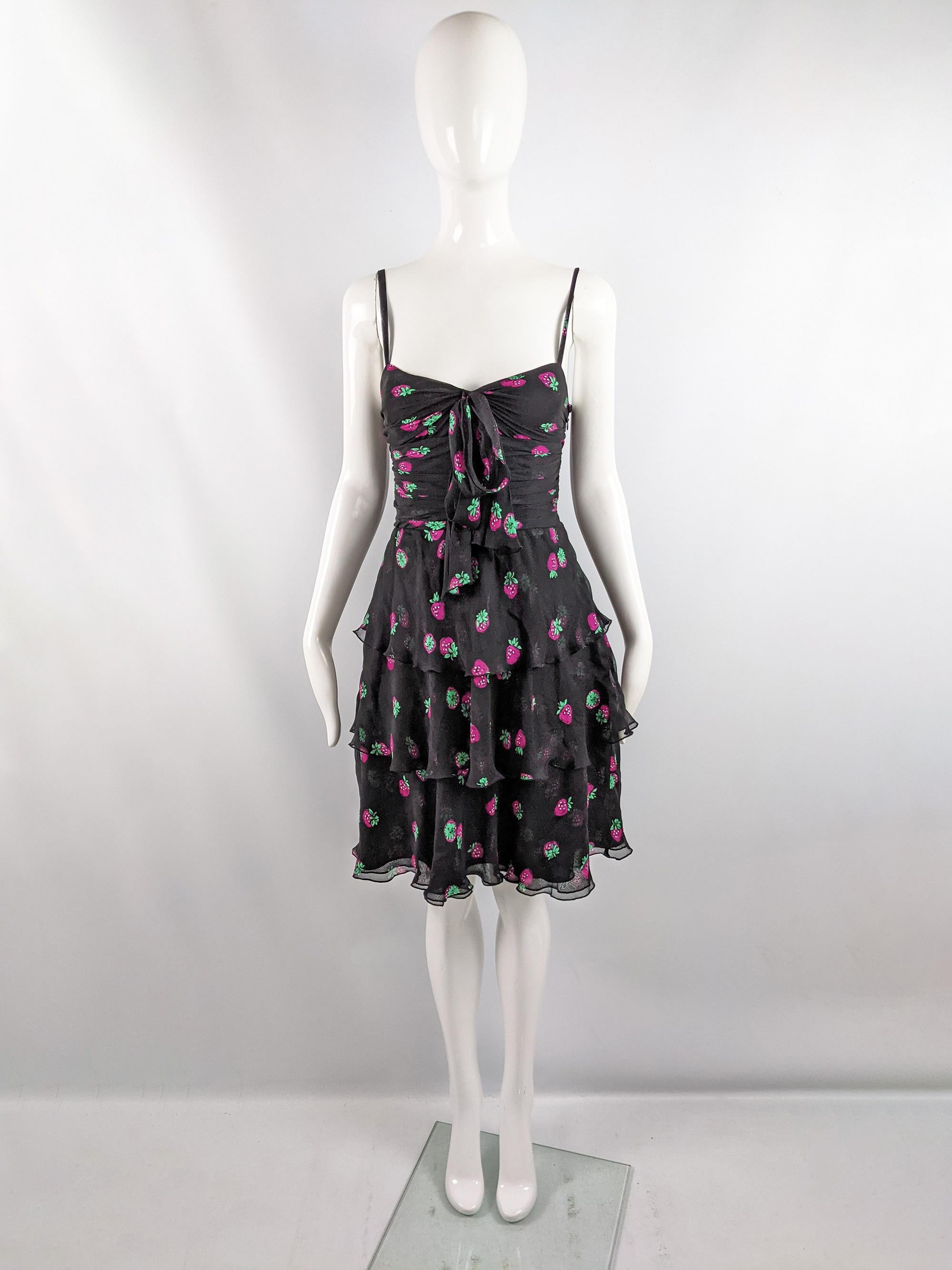 A super cute sleeveless vintage Moschino strappy party dress from the late 90s / early 2000s. In a black pure silk chiffon with a sweet, pink strawberry pattern throughout and a frilly / ruffled tiered skirt and ruched bodice. Perfect for the day in