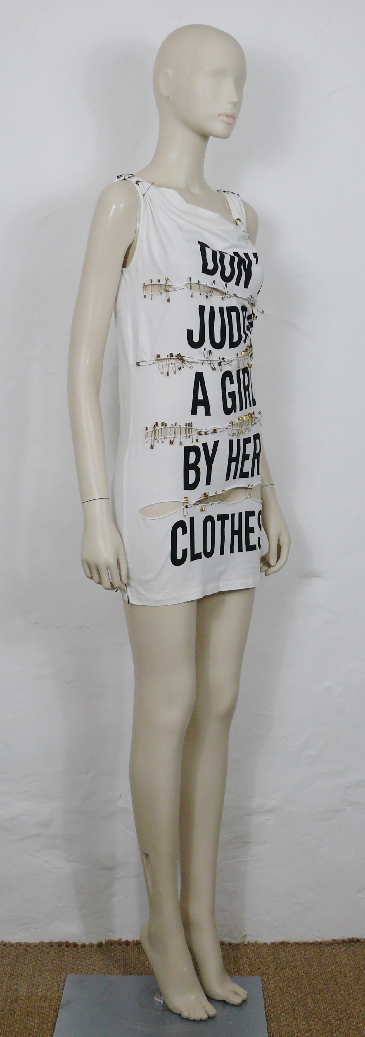 MOSCHINO vintage white cotton blend jersey DON'T JUDGE A GIRL BY HER CLOTHES mini sleeveless dress.

This dress features :
- White cotton blend jersey.
- Slashed front.
- Cowl neck.
- Gathered shoulders.
- Black slogan print 