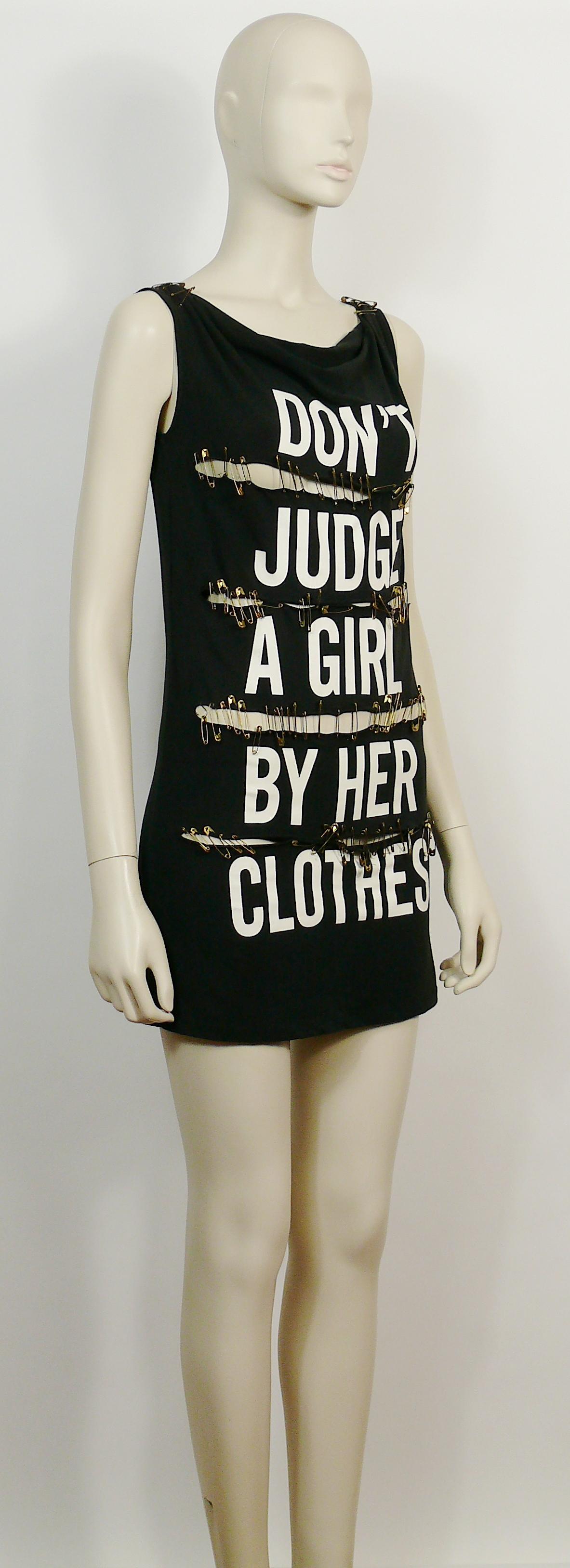 MOSCHINO vintage black cotton blend jersey DON'T JUDGE A GIRL BY HER CLOTHES mini sleeveless dress.

This dress features :
- Black cotton blend jersey.
- Slashed front.
- Cowl neck.
- Gathered shoulders.
- White slogan print 