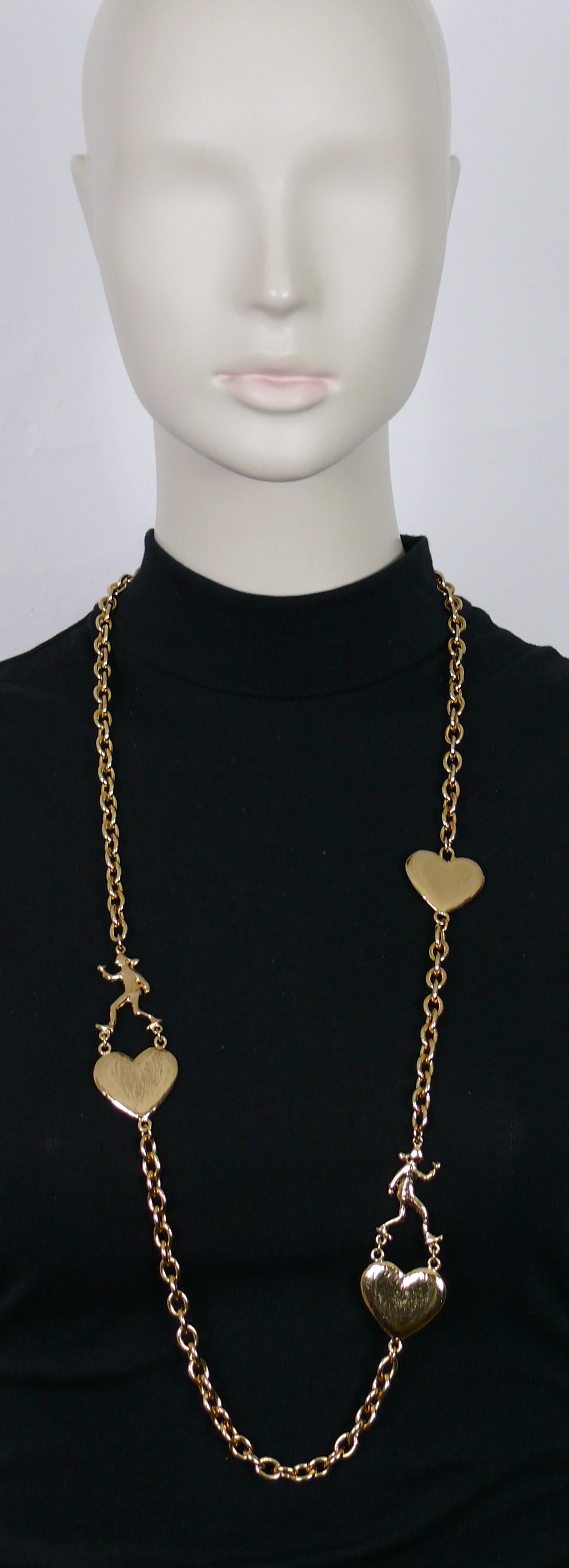 MOSCHINO vintage gold tone chain necklace featuring hearts and OLIVE OYL figures.

Spring clasp closure.

Embossed Cheap and Chic by MOSCHINO.

Indicative measurement : length approx. 93 cm (36.61 inches) / chain link width approx. 0.7 cm (0.28