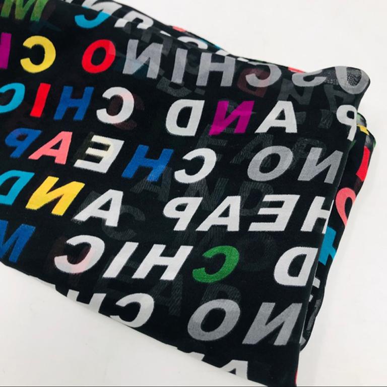 Moschino vintage graffiti black silk scarf

This vintage scarf is very Moschino with the brand logo in block letters all over. Sheer. There is a pull through part of this scarf on one side that is 11 inches long.
Width - 20 inches
Length - 62