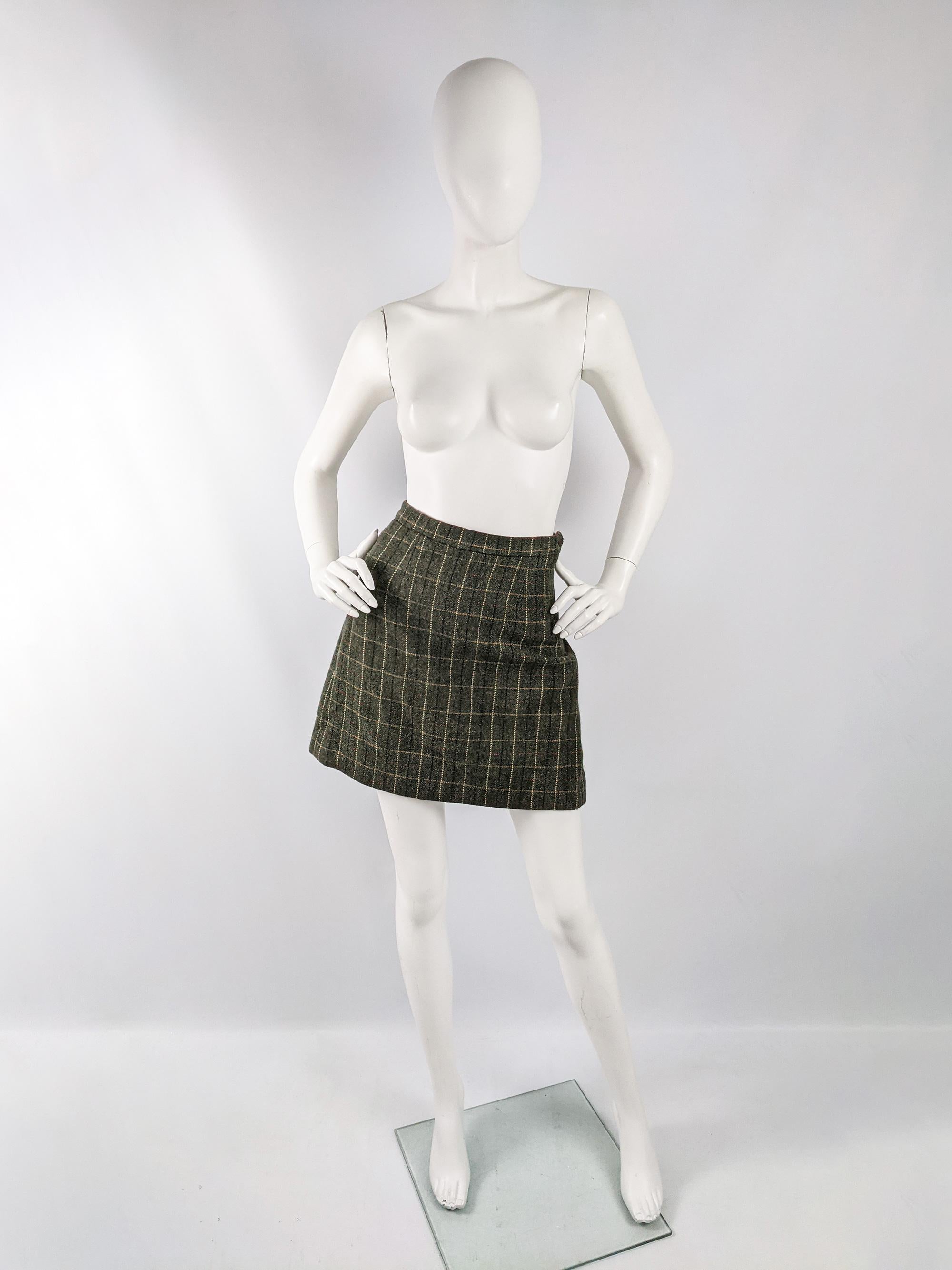 A cute vintage womens Moschino skirt from the 90s in a green wool with a red, yellow and black windowpane check / plaid pattern throughout and pleating and a statement bow at the back creating an almost bustle effect.

Size: Marked vintage IT 40 but