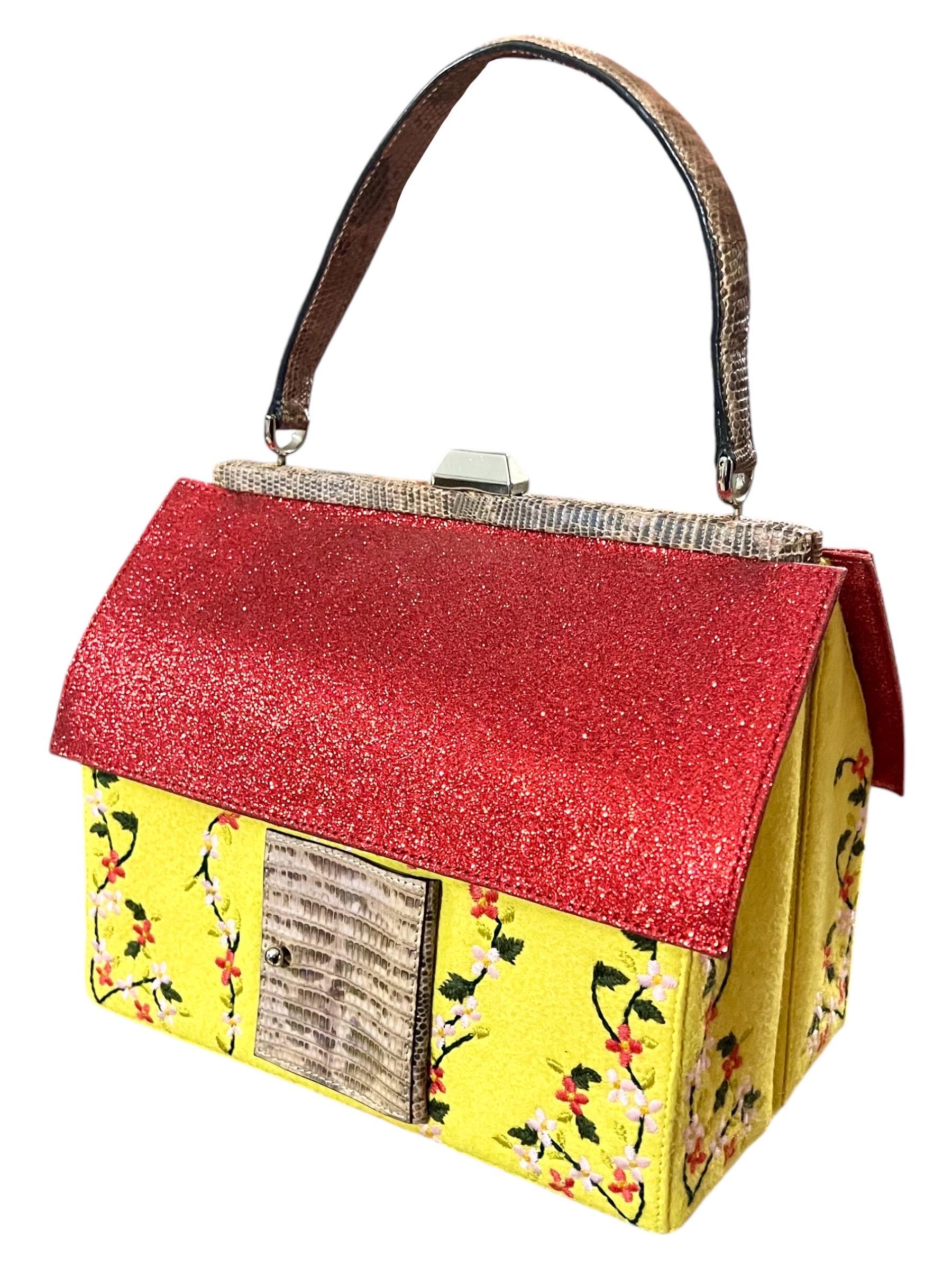 Whimsical vintage Moschino Hansel and Gretel gingerbread house bag from 2000
Red shimmering roof, pink python front door and strap. Yellow suede walls with a floral embroidered design 
Push lock clasp
Front door opens to a mirror


Condition: Good