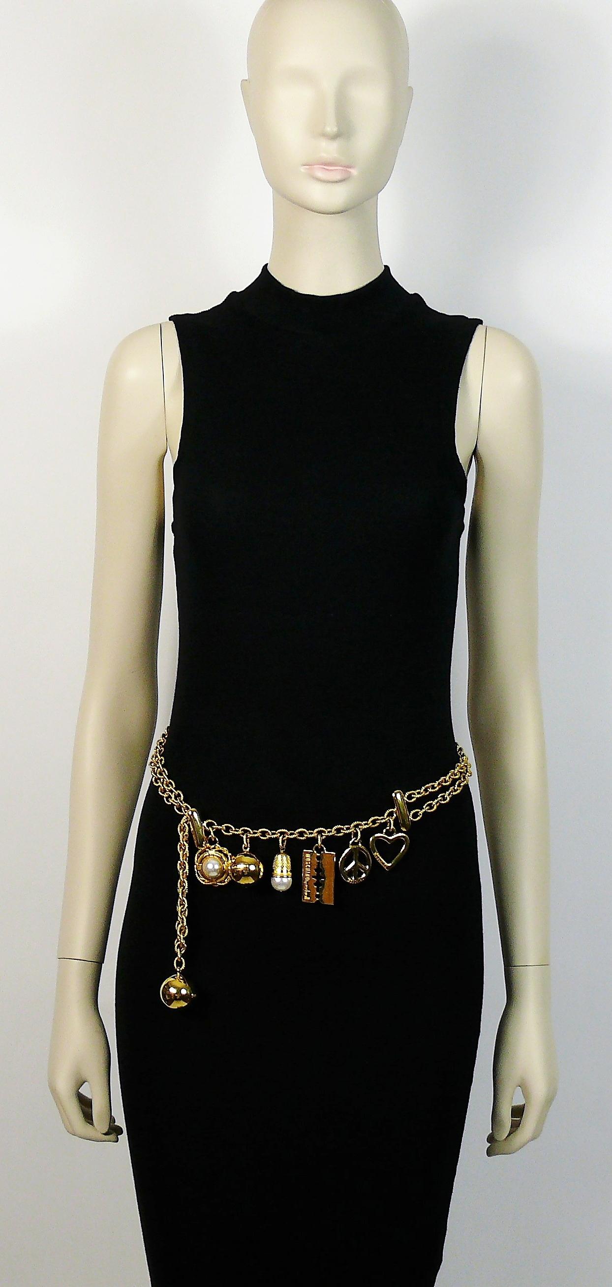 MOSCHINO by REDWALL vintage iconic gold toned belt/necklace featuring charms : golden balls, heart, peace sign, razor blade, thimble and ring buoy embellished with faux pearl.

Two tiered chunky textured chain.
Hook clasp.

Could be used as a