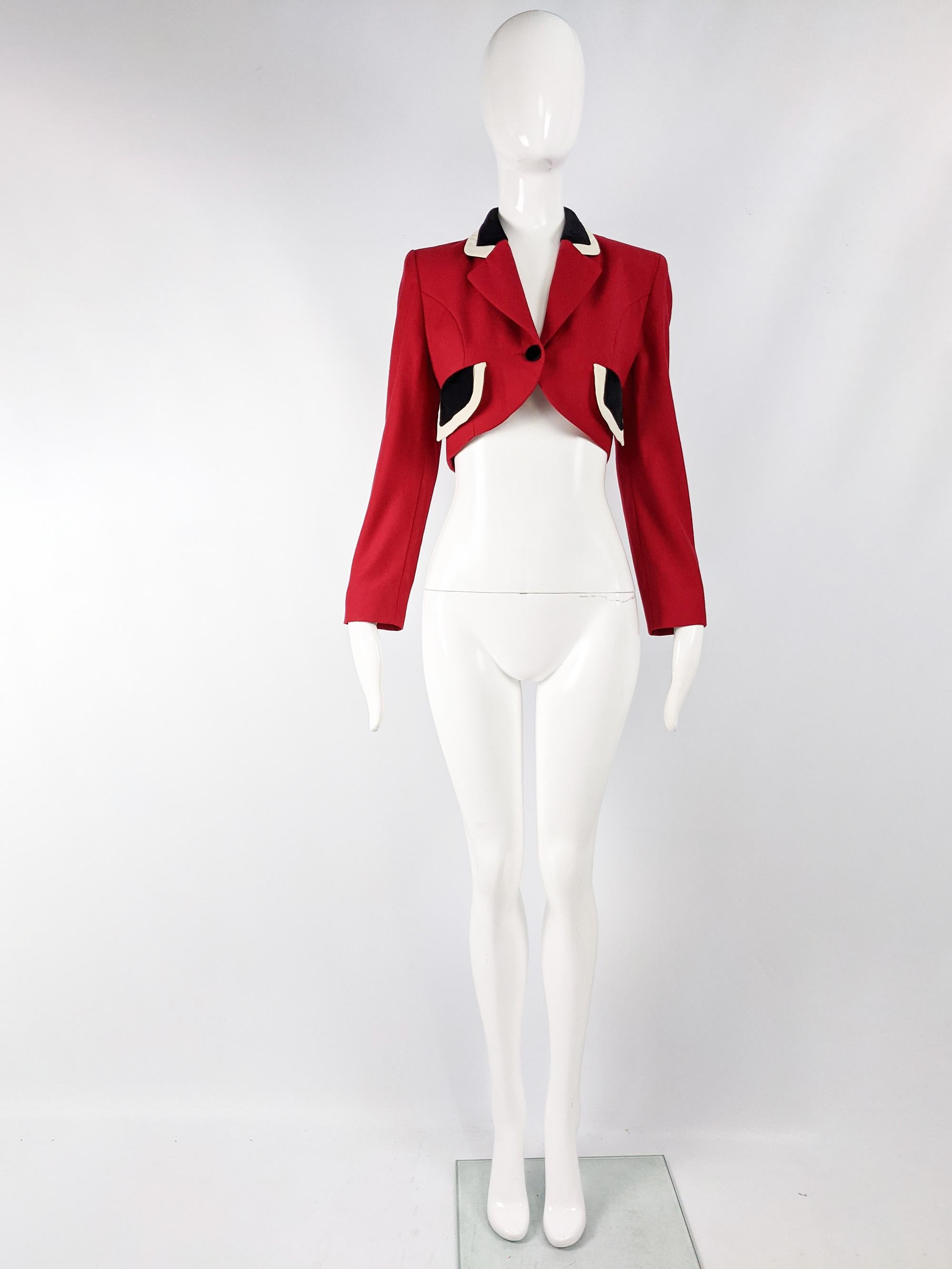 A chic vintage womens Moschino cropped blazer jacket from the 80s. In a red wool crepe with a black and white collar and pocket flaps. It has Moschino's iconic black and white vertical striped lining. 

Size: Marked IT 38 but really fits like a