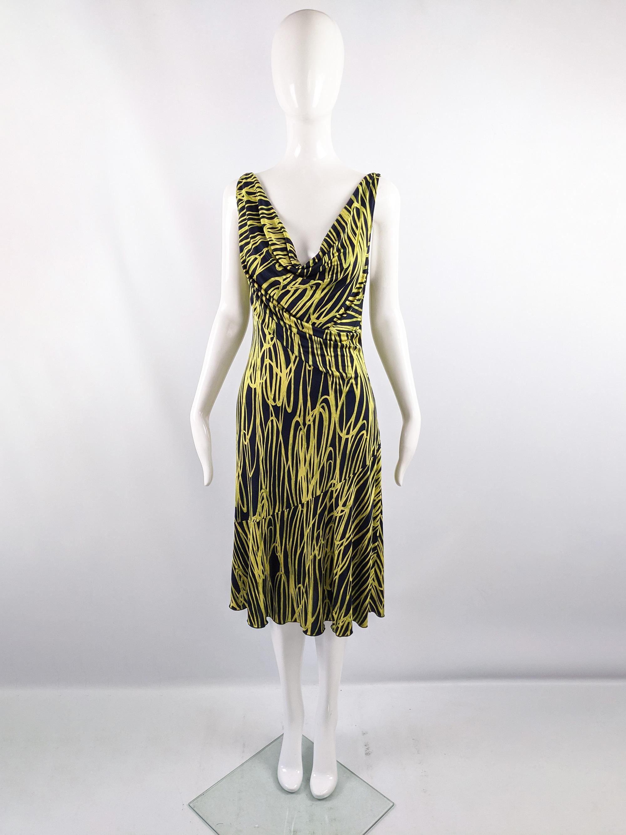 A sexy vintage sleeveless Moschino dress from the early 2000s. In a navy blue and yellow silk blend jersey which has amazing drape. It has a plunging neckline with a cowl effect, making it perfect for a party. 

Size: Marked vintage IT 46 but