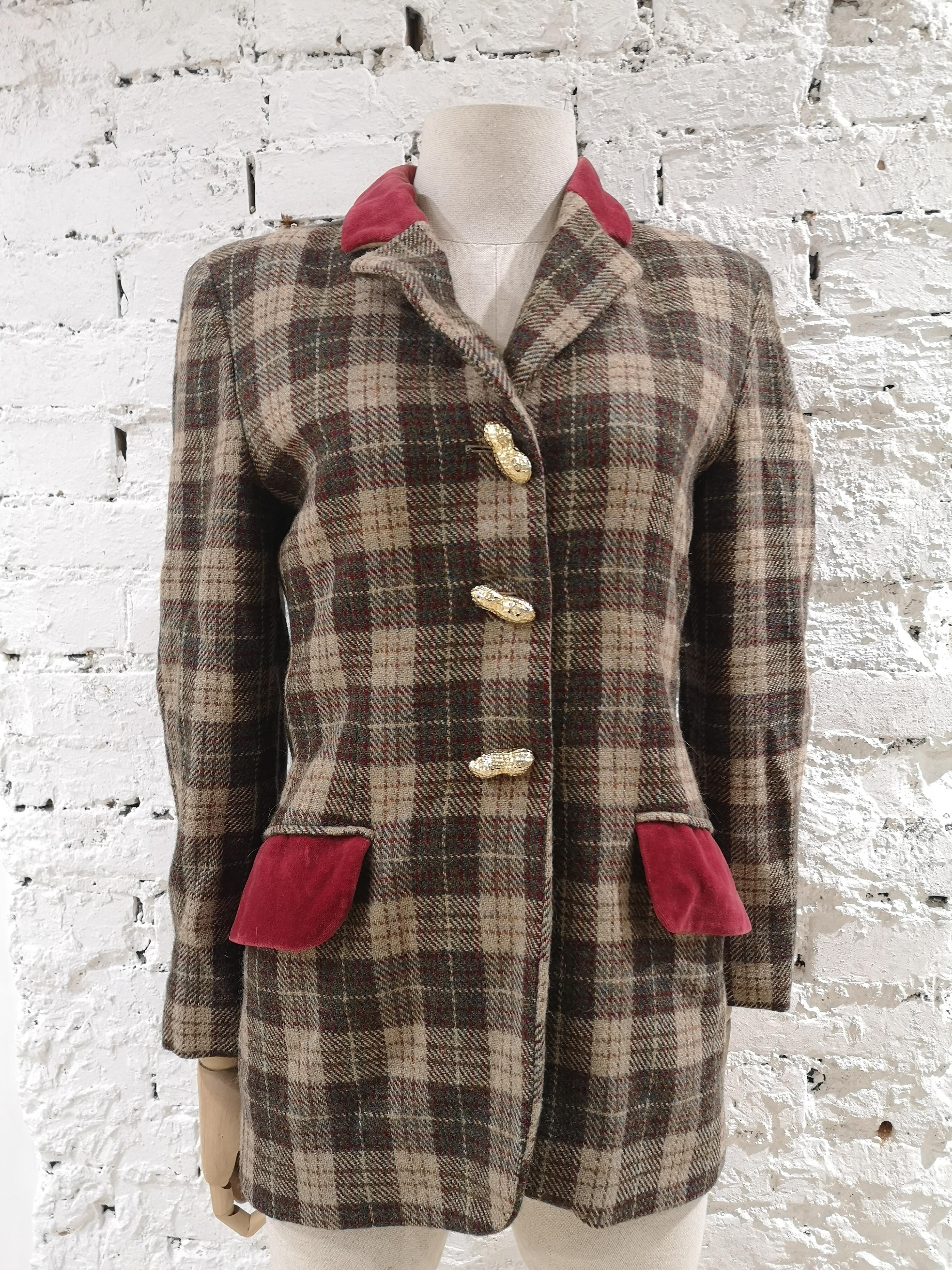 Moschino wool nuts jacket
multicoloured wool jacket embellished with gold tone nuts buttons and red velvet tasks and collar
totally made in italy in size 42