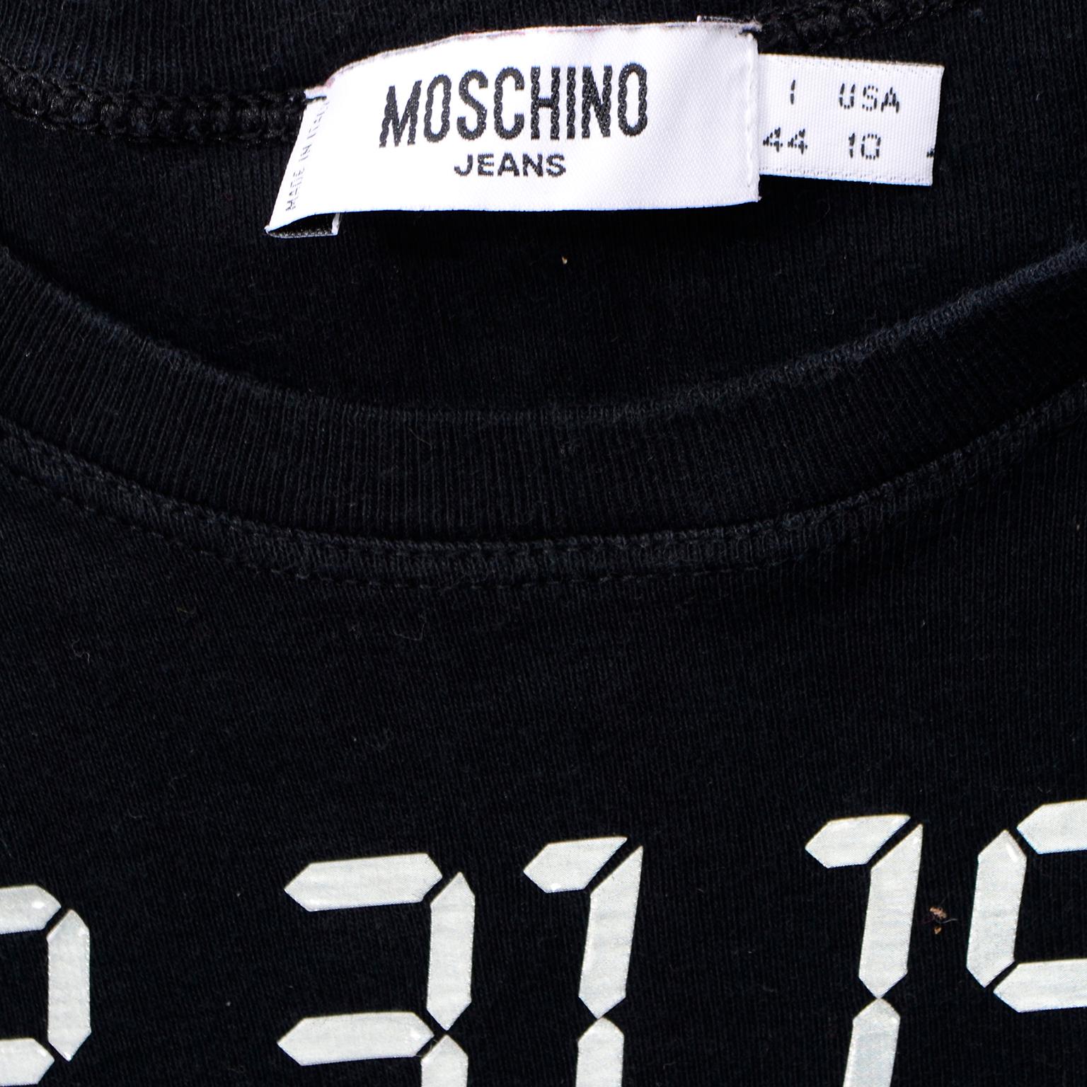 This is a rare,  incredible vintage black, long sleeve cotton novelty shirt from Moschino that was created as a humorous nod to the anticipation of the Y2K Bug. Leave it to Moschino to find a way to make something like Y2K a fashion statement! 

For