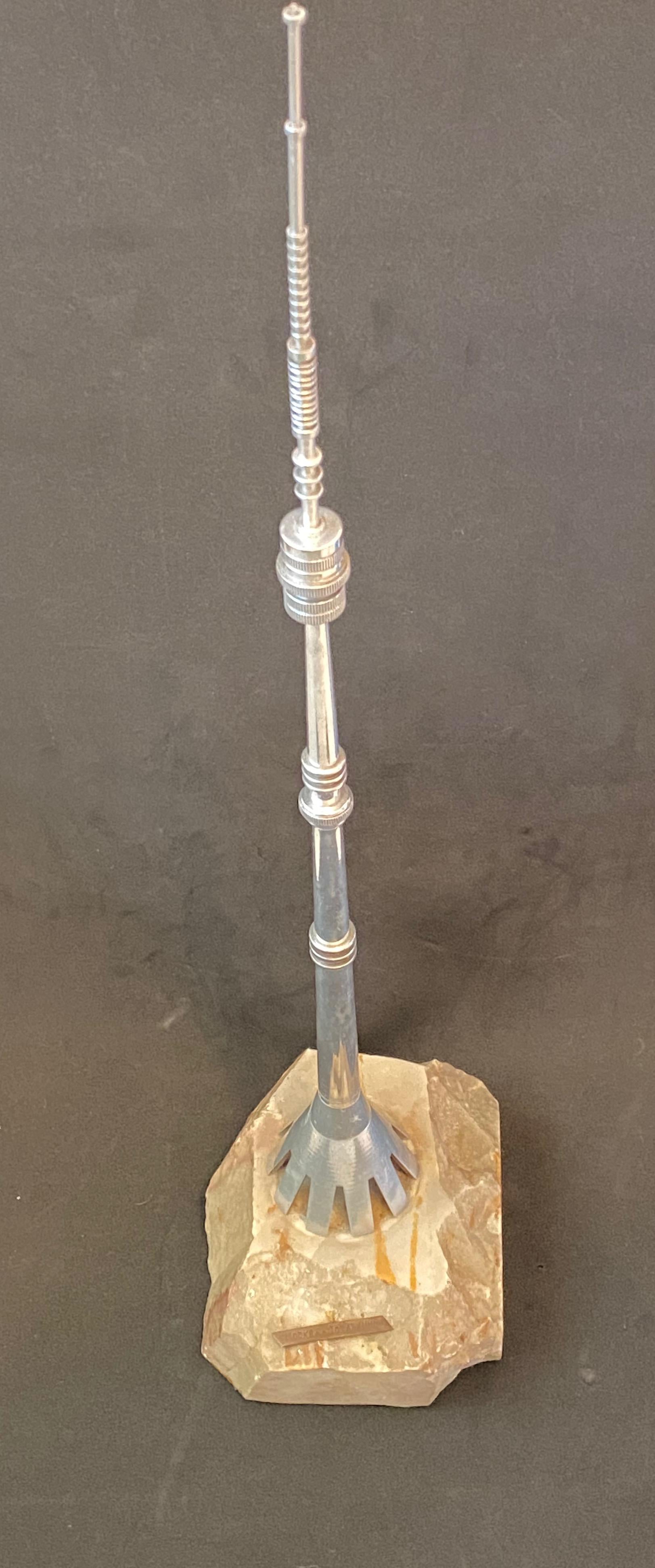 Scaled model of the Moscow Ostankino Tower, television tower. Hand-spun in aluminium, fixed at a stone base. A nice architectural Sculpture for every living room or man cave.