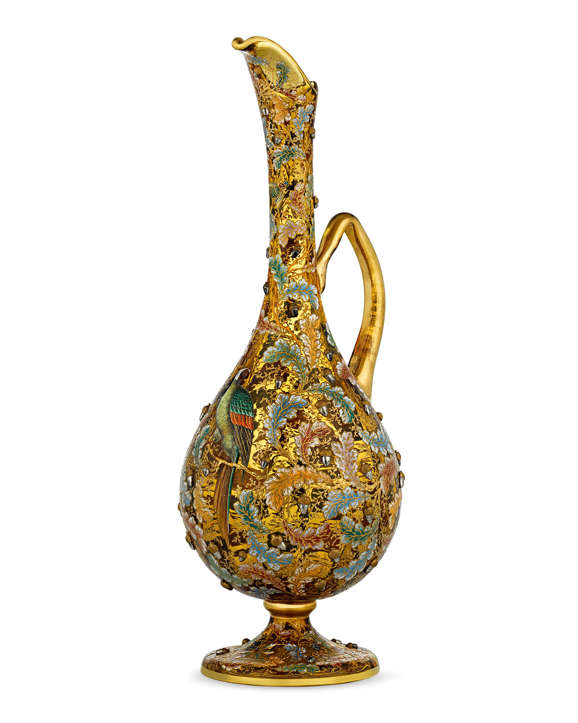 Charming, brightly colored enamel decoration distinguishes this exquisite amber glass ewer by Moser. Applied enamel acorns are surrounded by colorful foliage in this highly desirable wildlife motif from the firm, which perfectly captures the