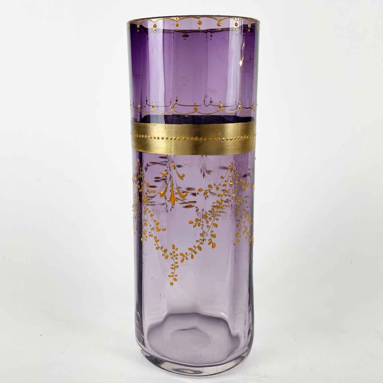 The handmade glass vase is a purple lavender amethyst color, an exceptionally wonderful color. The shape is slightly oval and faceted, the rim has a gilt strip decorated with rose coral color beaded motif. The body of this antique glass vase is