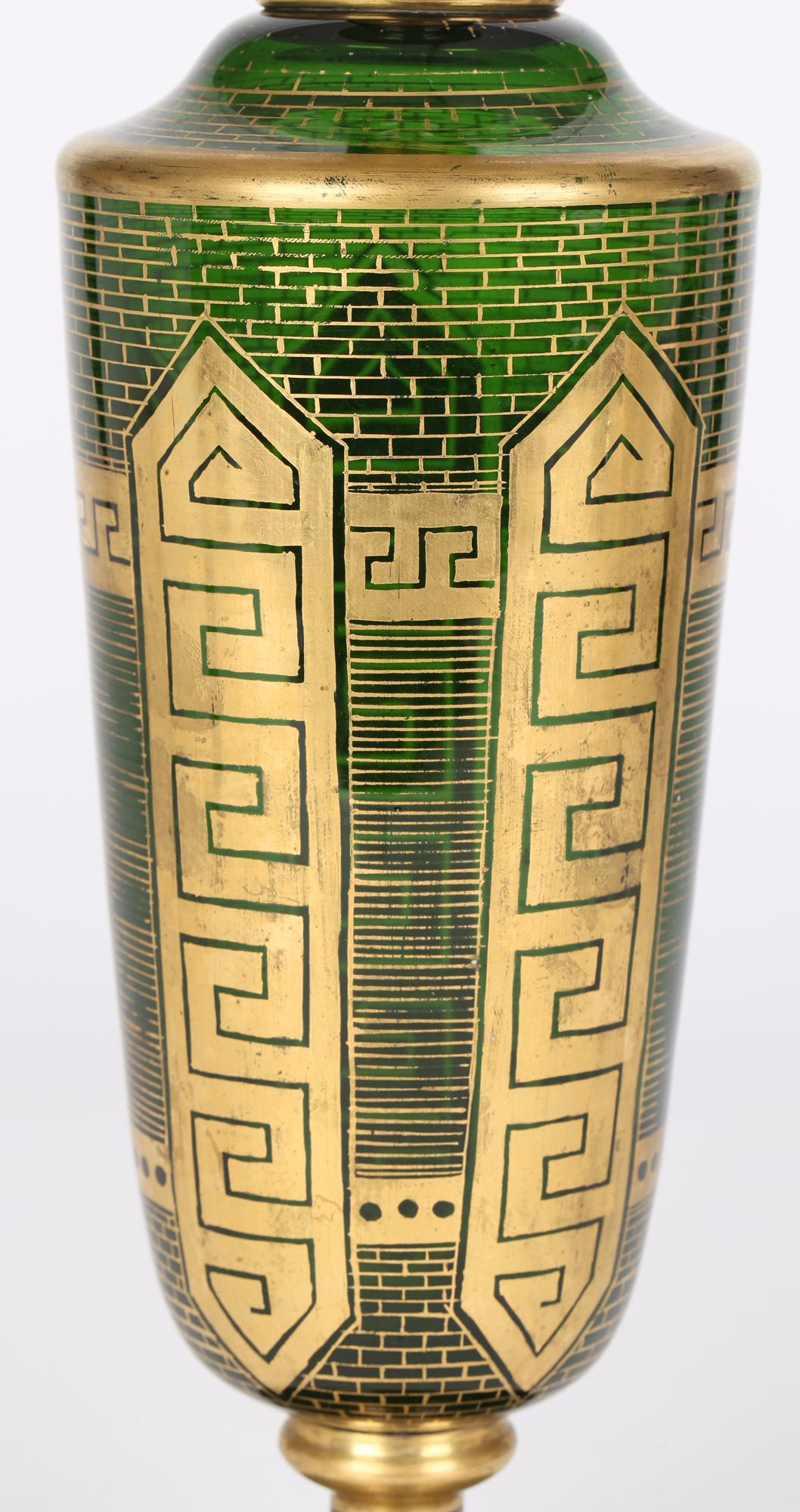A very fine and tall antique Bohemian green glass vase decorated with gilding, attributed to Moser and dating from the latter 19th century. This elegant and impressive vase stands on a rounded pedestal base with knop stem supporting a tall round