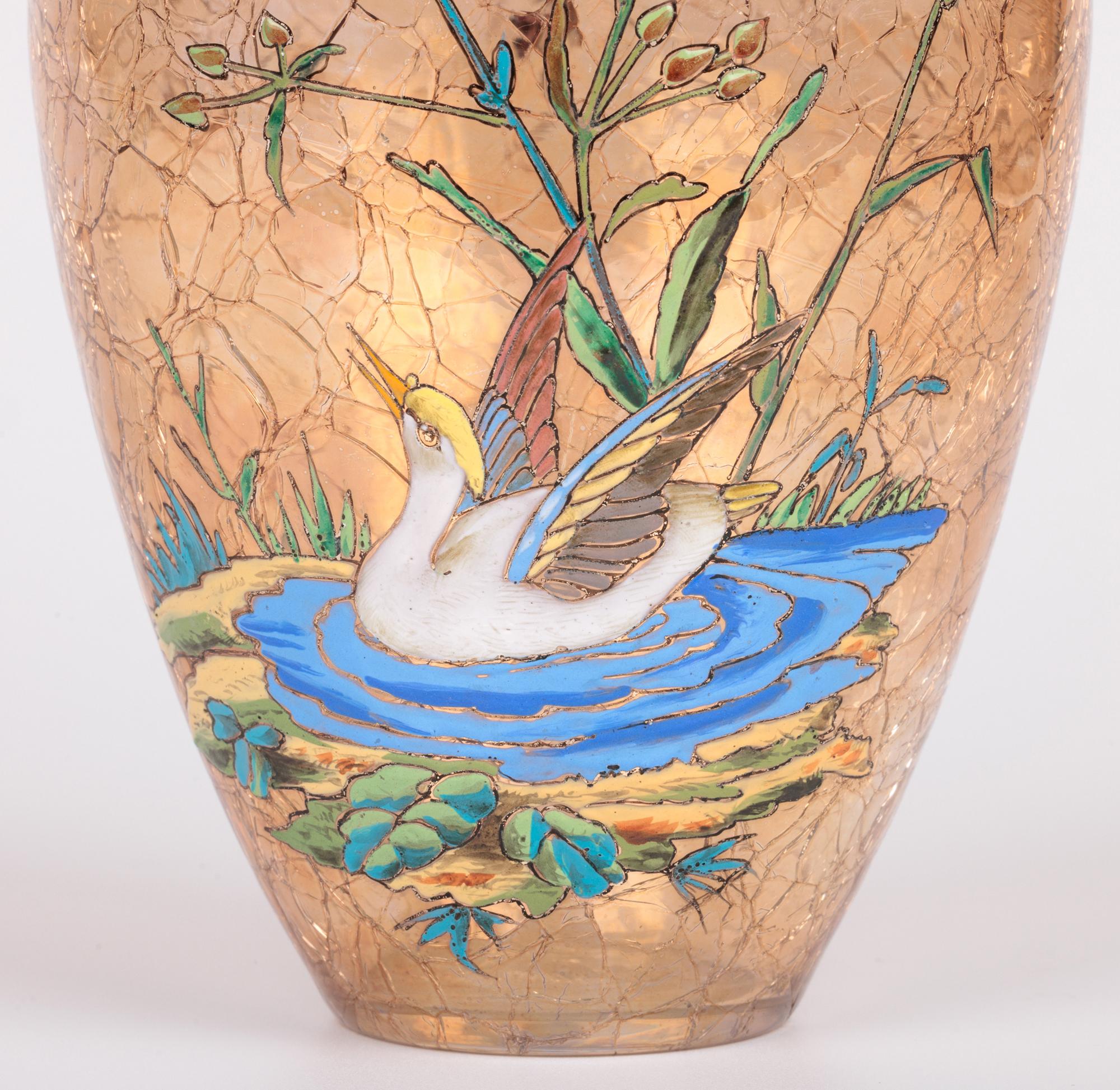 A stunning antique Bohemian art glass craquel design vase decorated with two water birds amidst foliage and water made at the renowned glass works Moser and dating between c.1895 and 1925. The hand-blown vase stands on a narrow round base with a