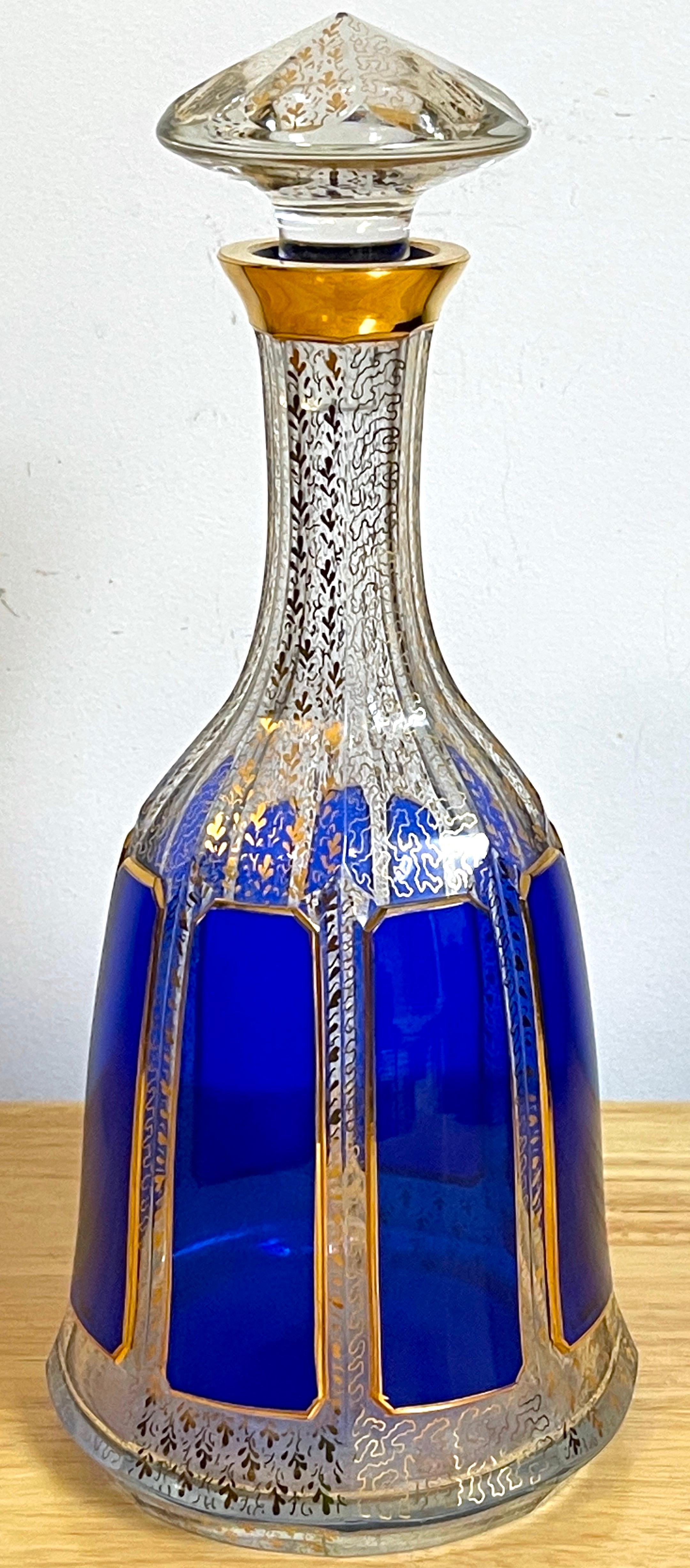 TMoser cobalt cut to clear & gilt enameled decanter.
Czech Republic, !930s.

A substantial decanter, beautifully executed with continuous gilt decoration with deep cut cobalt panels. retains the orignal matching stopper. Unmarked.



