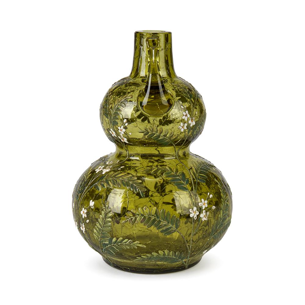 A stunning antique Moser art glass double gourd twin handled vase in green crackle glass and overpainted in colored enamels with fine white flowering shrubs. The vase has small pulled handles attached to top rim and is not marked.