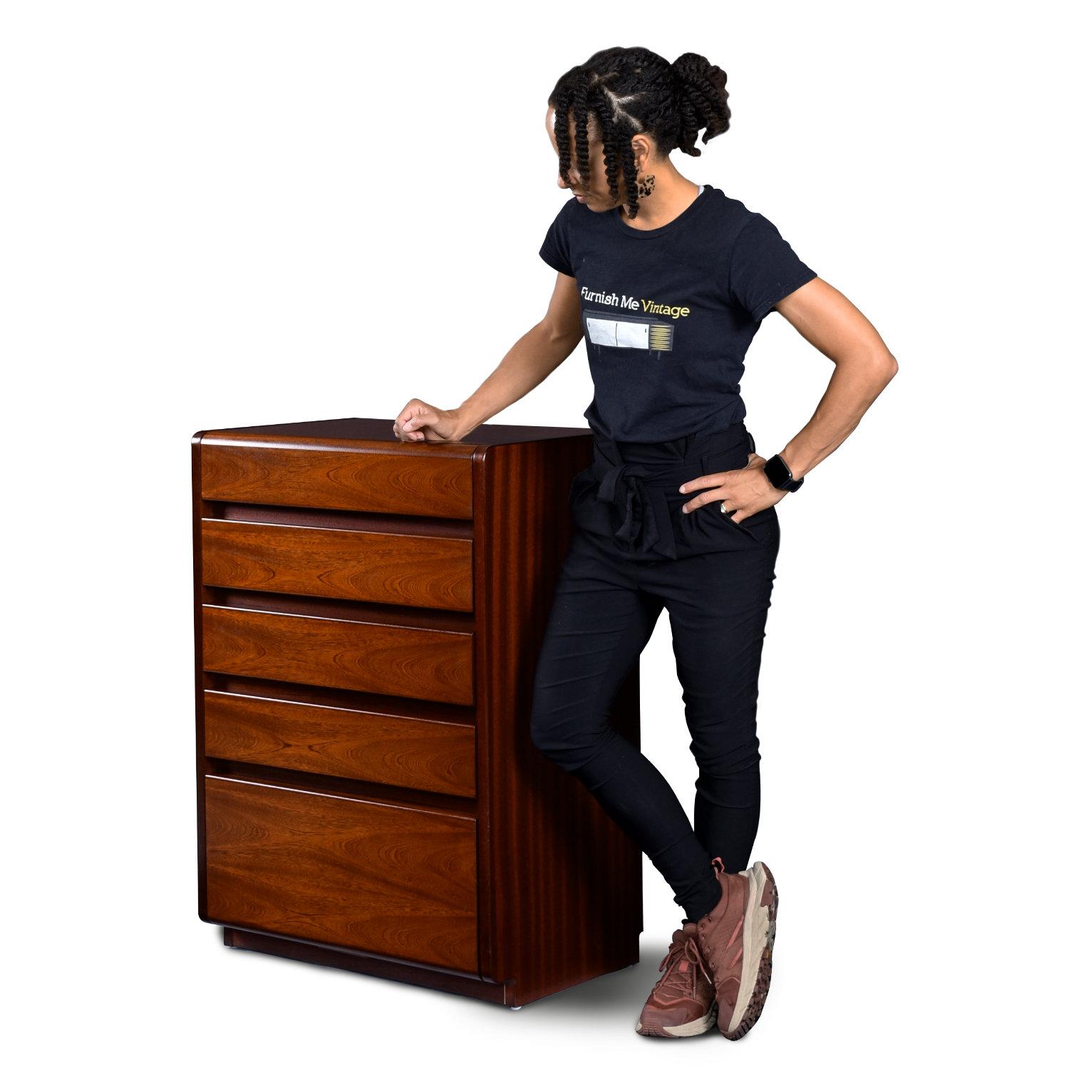 Unique German Modern rosewood small vertical dresser by Moser. This five drawer “high boy” is not quite so high. It stands at 37″ tall, but still packs quite a bit of storage capacity. A deep bottom drawer accompanies the four typical size drawers.