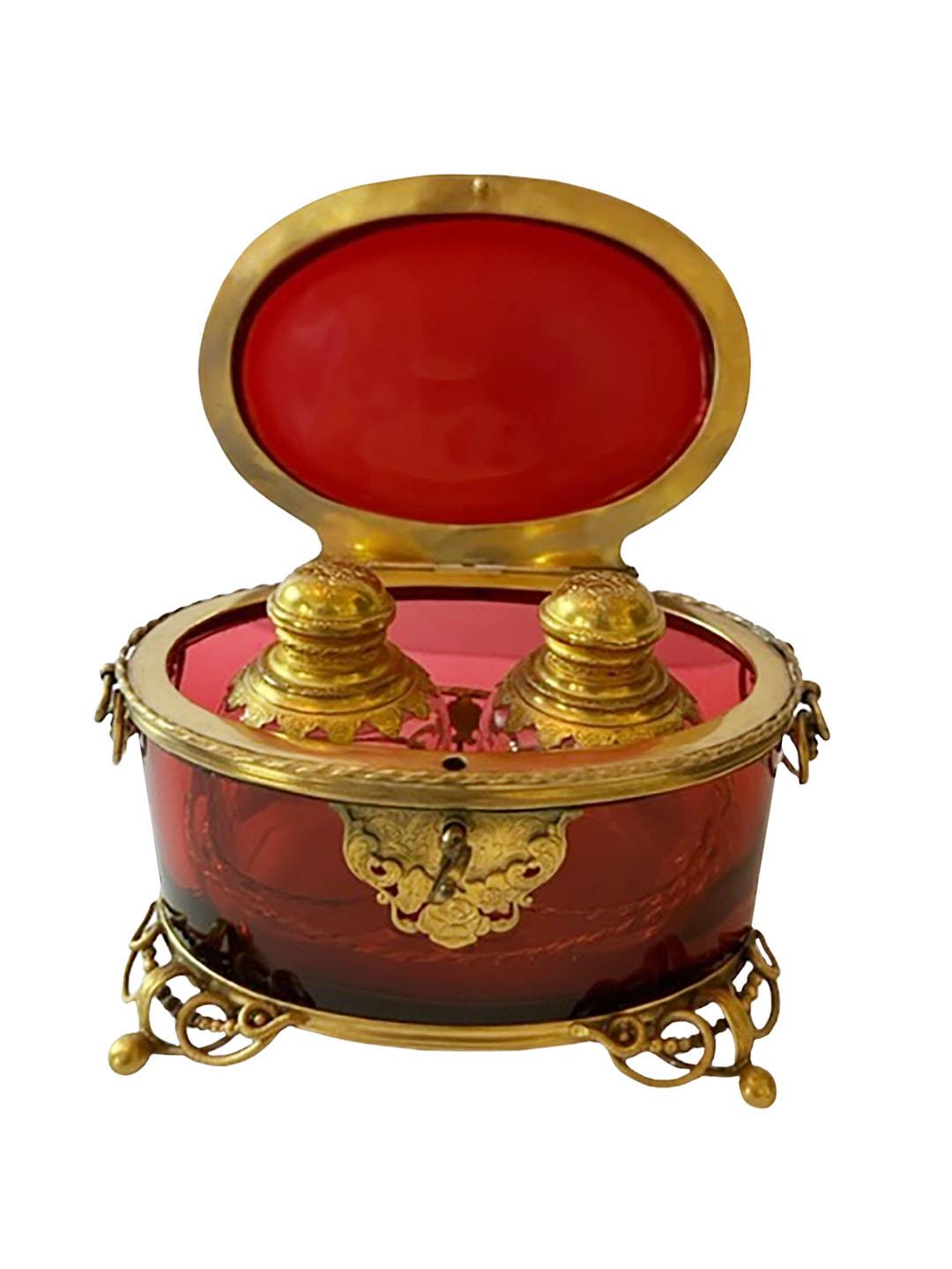 Grand tour Moser Bohemian flashed red crystal box. The interior fitted with two
original scent bottles. All bronze dore in very bright condition. All in mint condition. With key. Circa 1890.