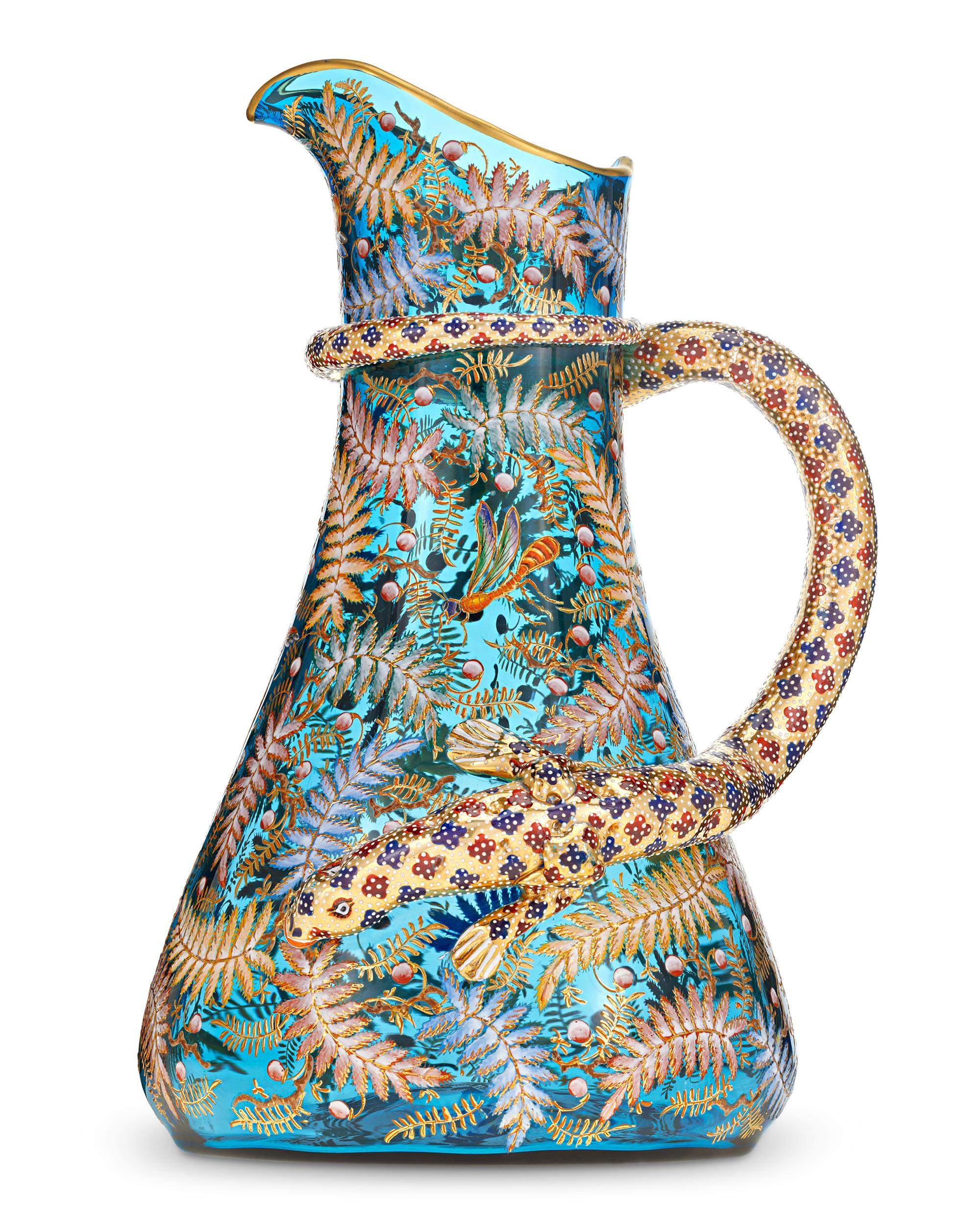 Pitcher with Enameled Bird and Salamander
Moser
Circa 1890

Fantastic wildlife decoration distinguishes this rare Moser glass pitcher. Crafted of luminous blue glass, this large pitcher is adorned across its surface with the signature Moser gilded