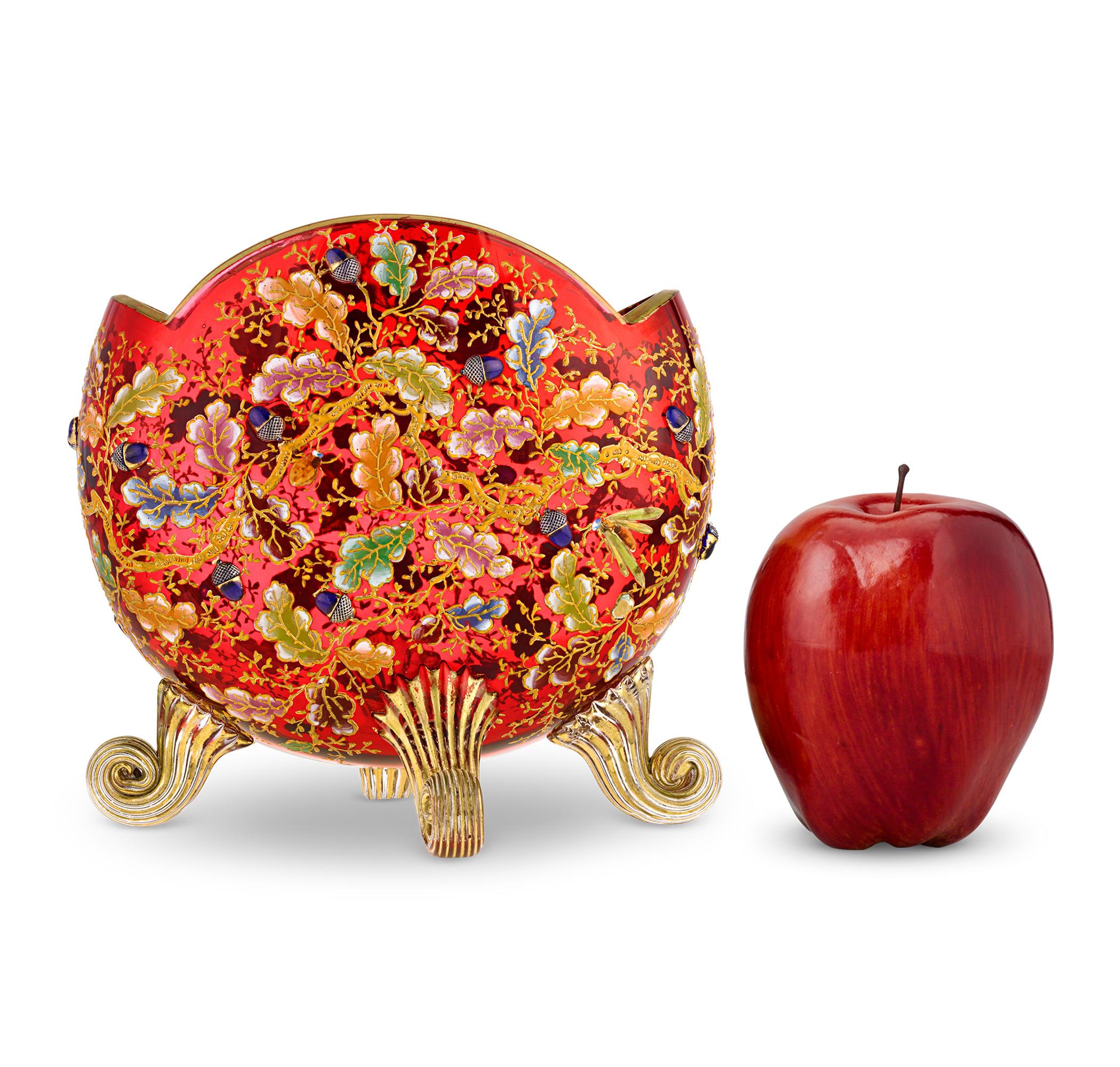 Gilt and Enamel Red Pillow Vase
Moser
Late 19th Century

A masterpiece of artistry and craftsmanship, this exquisite Moser pillow vase dazzles with its rich ruby glass and intricate gilded detailing. Enamel oak leaves and relief-molded acorns form a