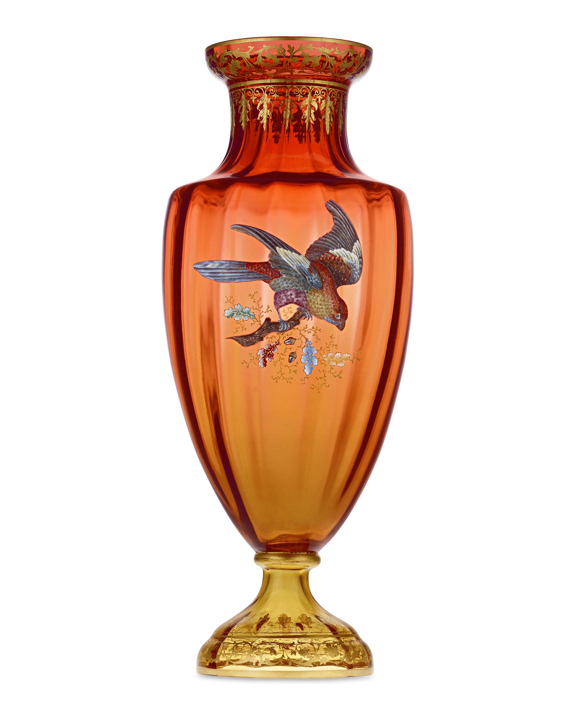 An exceptional avian motif graces this large glass vase by the revered Czech firm Moser. The raised enamel bird is matched well by the gilded amber glass. Recognized as the foremost Bohemian producer of artistic glassware, Moser has been crafting
