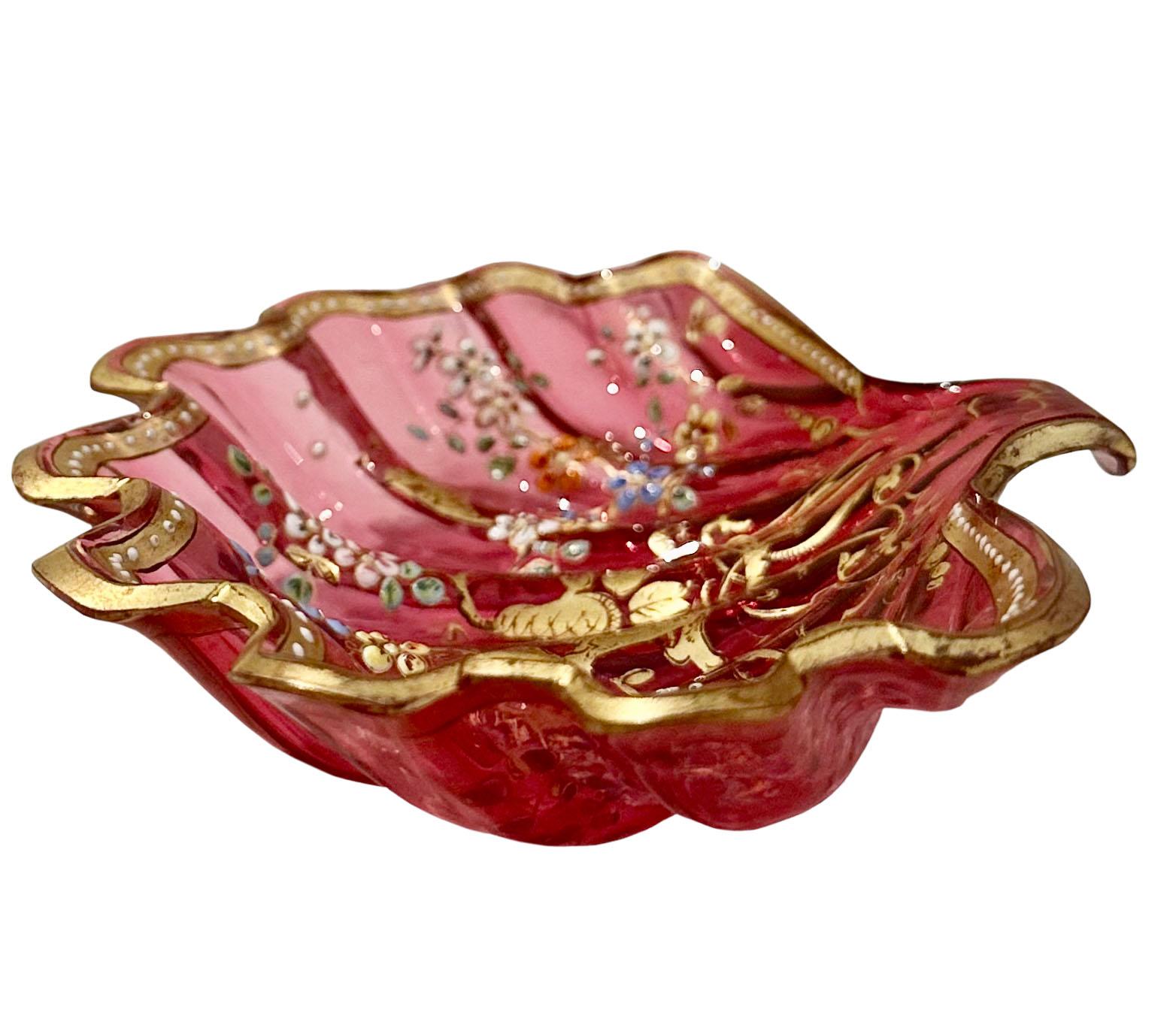 A Mosher cranberry bohemian glass dish circa 1850s to 1890s.  Beautifully decorated with a monogram of the original family. The flowers are enameled with gold gilt. It is a candy or nut dish, small but spectacular. 