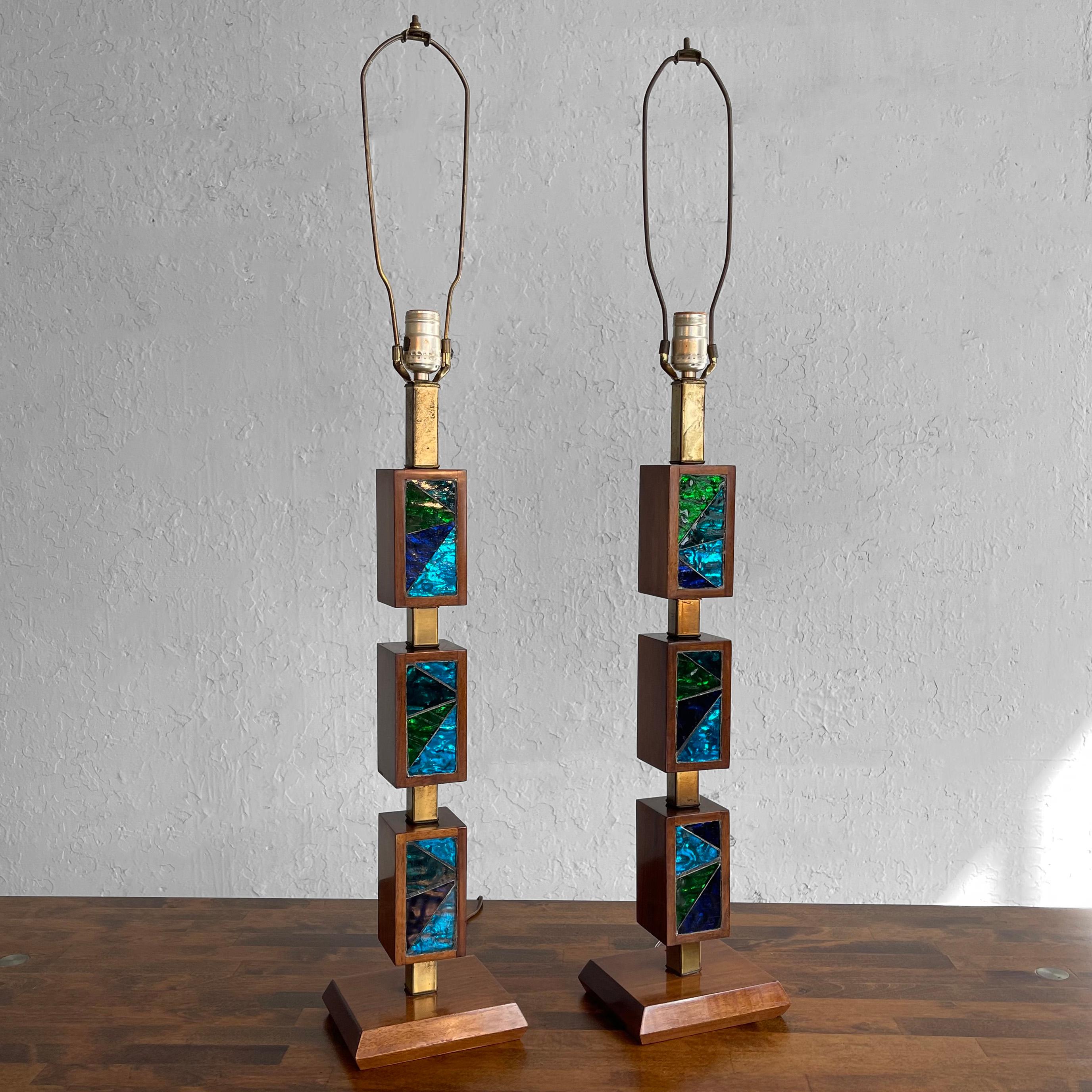 Pair of impressive table lamps by Georges Briard for Lightolier feature brass stems with walnut blocks of jewel-toned, mosiac glass in blues and greens that can be positioned differently. The lamps are 27 inches height to their sockets. The shades