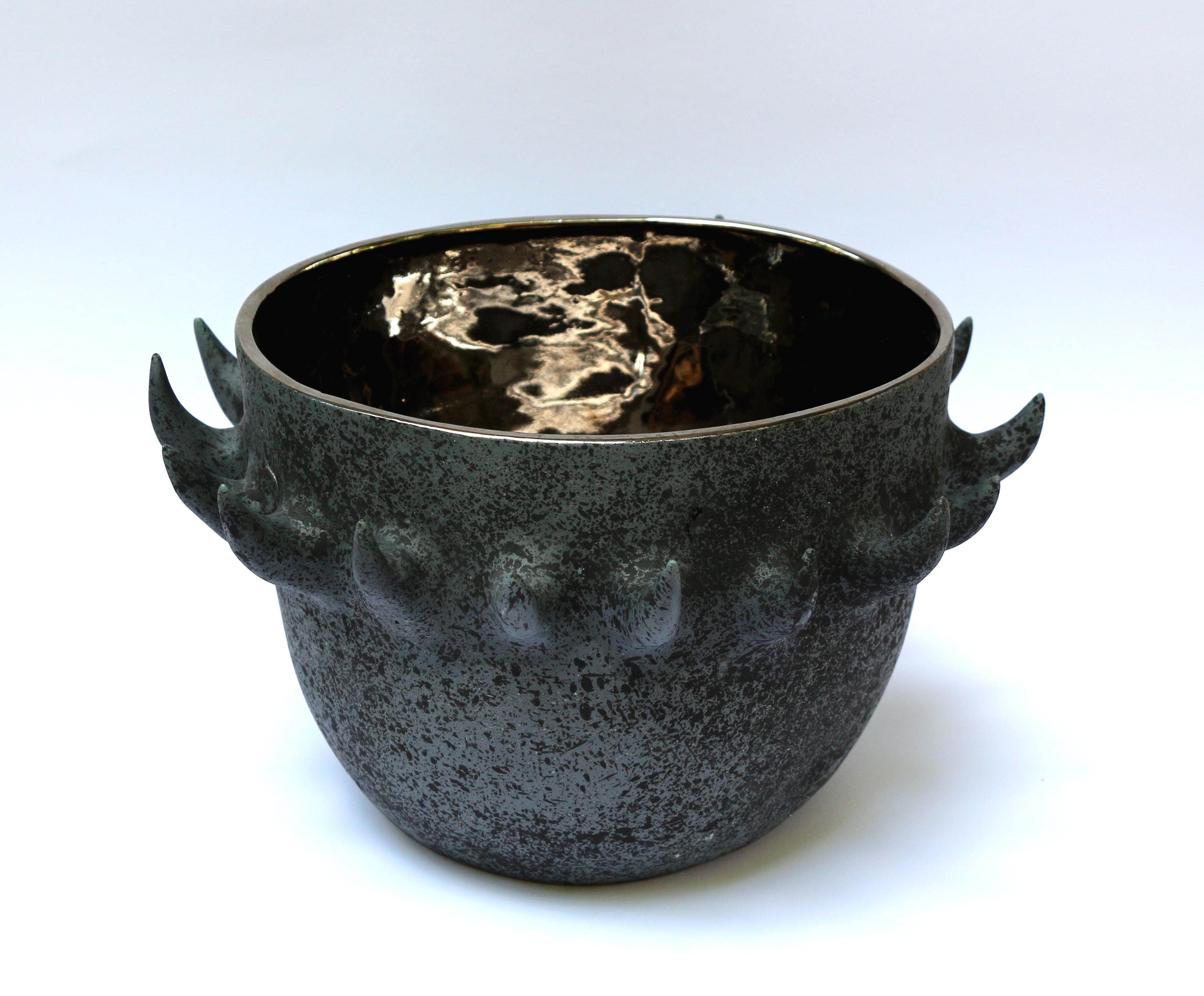 Mosko Eklektik bowl by Nów
Designed by Mosko 
Dimensions: D 33 x W 28 x H 20 cm
Materials: porcelain, platinum (or gold on demand)

Monika’s fascination for work with ceramic began with her first contact with soft clay. At first, formless mass