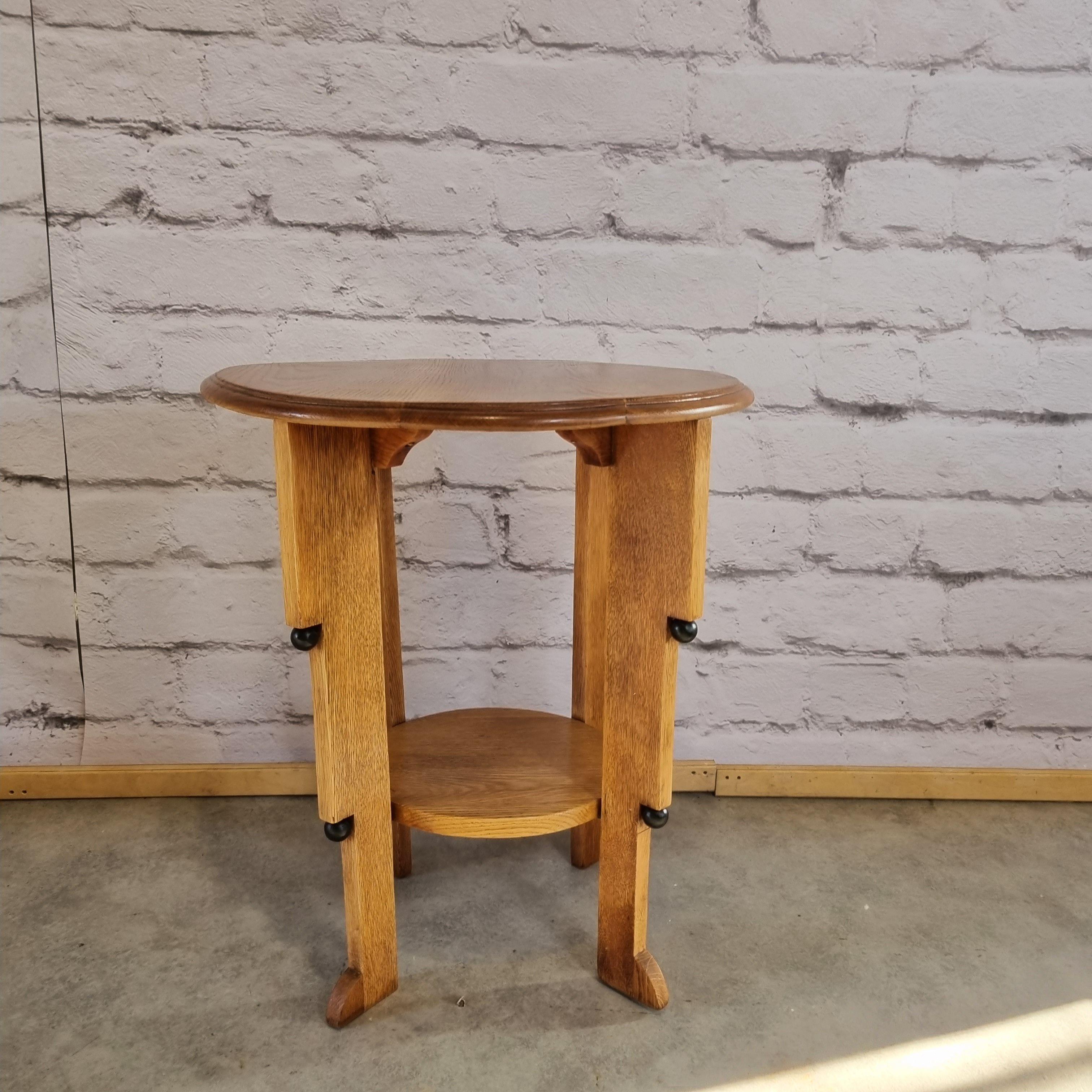 Oak side table made in the 1920's in the style of one of the leading designers of that period - Hildo Krop. Elegant form with characteristic black balls. Vey unique and beutifull example of the Amsterdam School design.