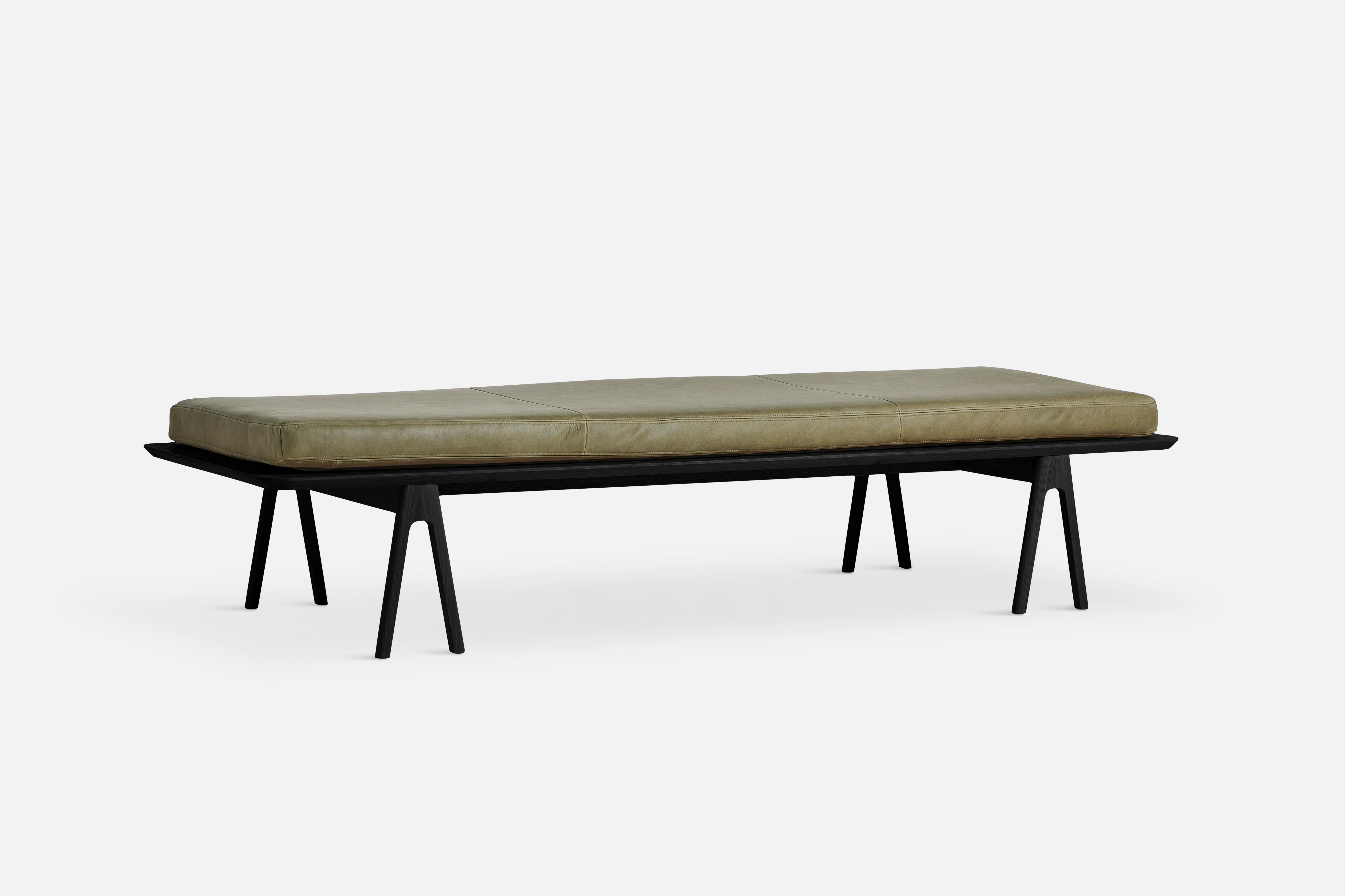 Moss green leather level daybed by MSDS Studio.
Materials: camo leather, foam, oak.
Dimensions: D 76.5 x W 190 x H 41 cm.

The founders, Mia and Torben Koed, decided to put their 30 years of experience into a new project. It was time for a