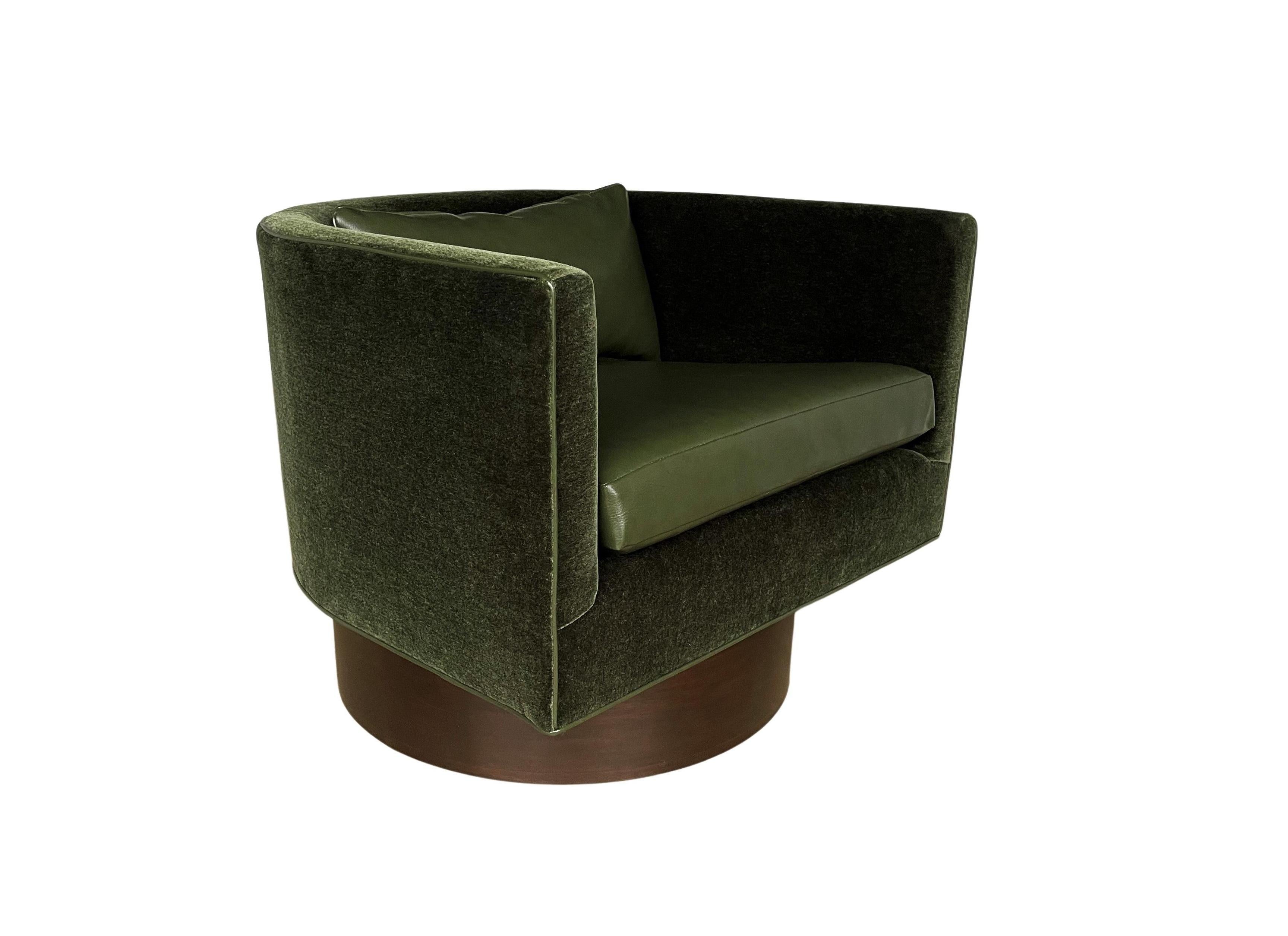 An exemplary and very rare pair of swivel chairs designed by Milo Baughman, circa 1960s. Completely restored, newly upholstered in a luxurious moss green mohair and resting on high stained bases. These bold club / lounge chairs are as versatile as