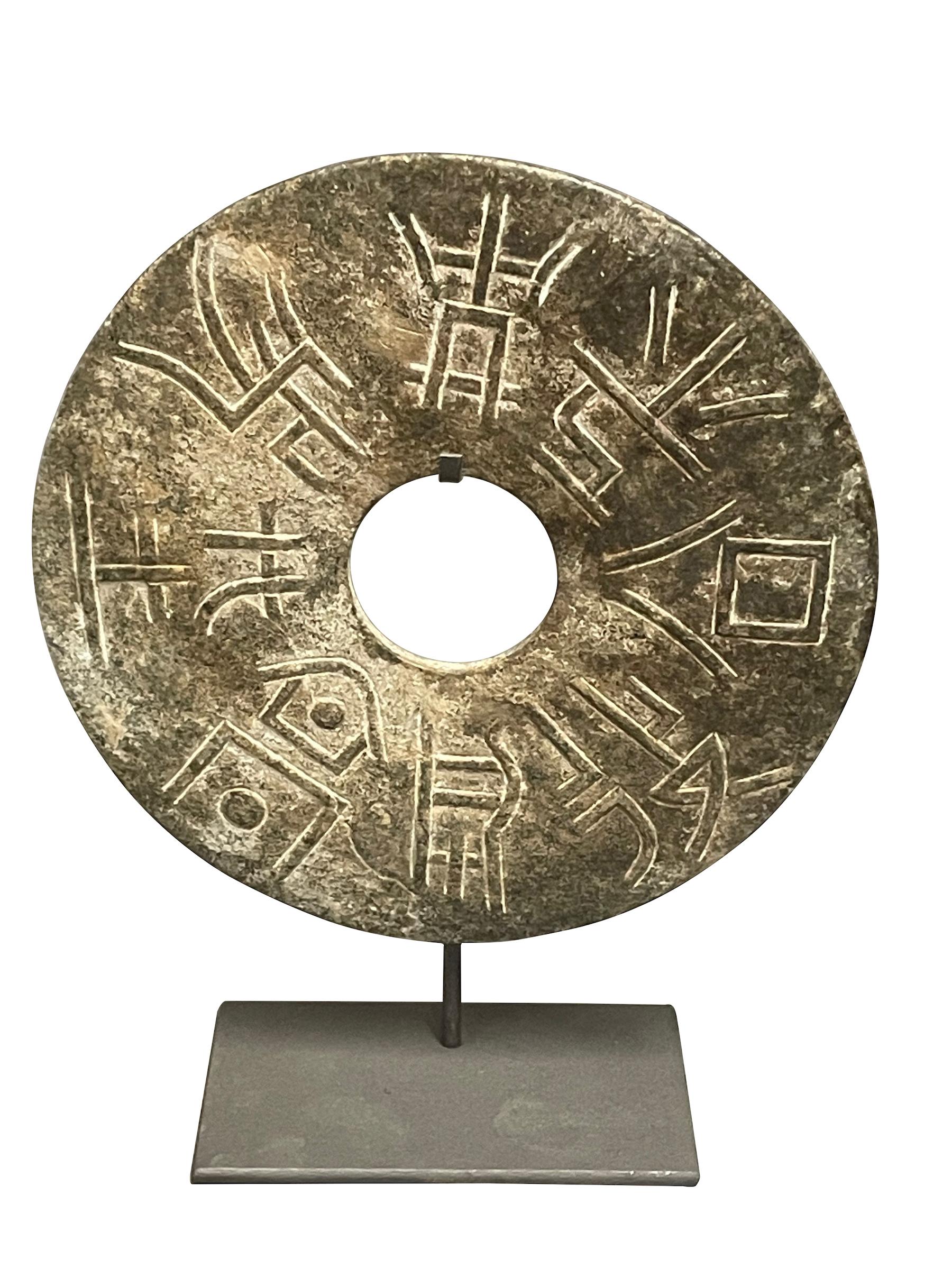 Contemporary Chinese single textured jade disc on metal stand.
Mottled moss green in color.
Stand measures  6  x  4
Sits well with hand carved stone semi circle with capital motif.
Sits well with hand carved abstract stone bird.
