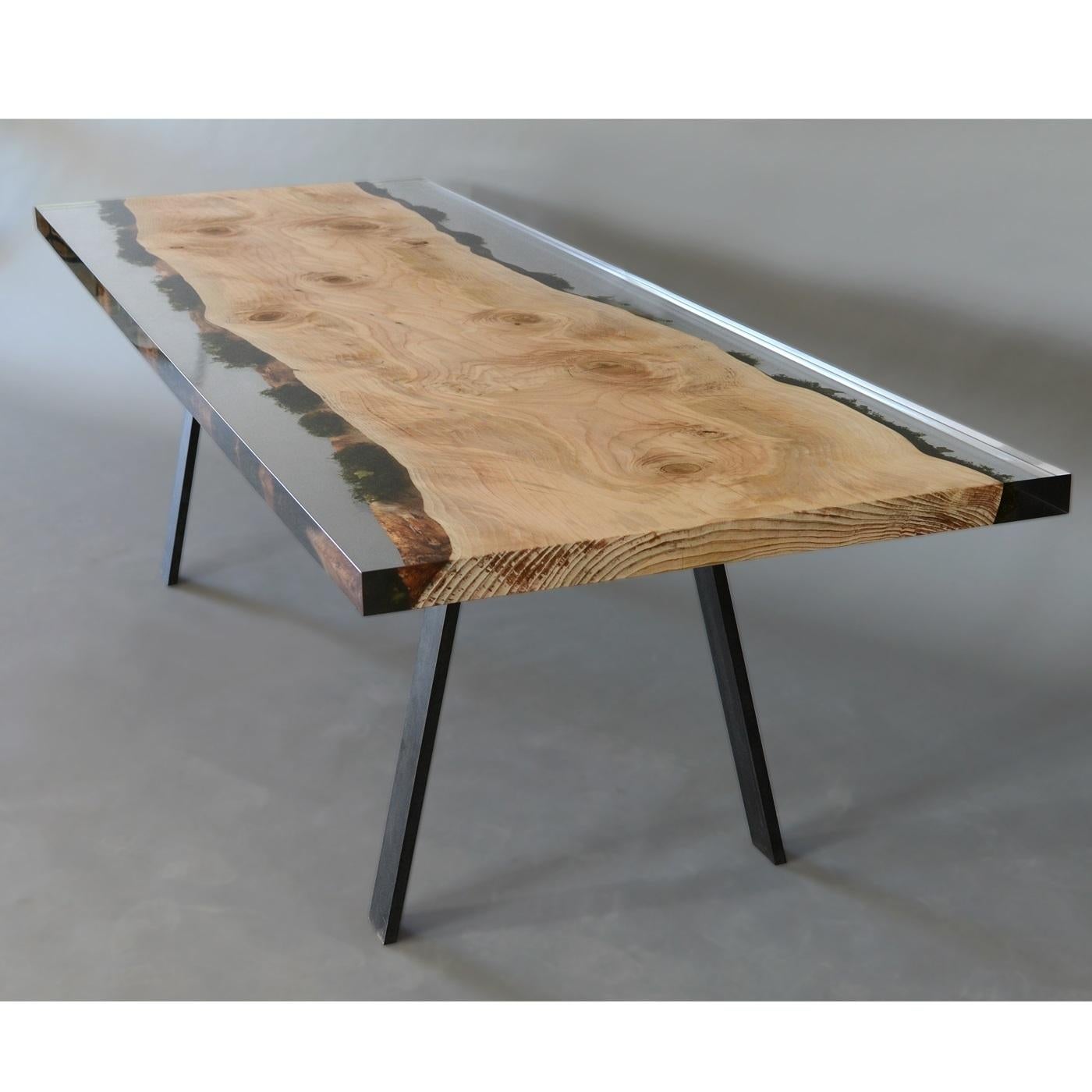 This unique table features a top crafted from a plank of wood found in the Dolomite forests, with its natural edges preserved along with the flora growing on it. This single plank of wood and its mossy edges are preserved by a special transparent
