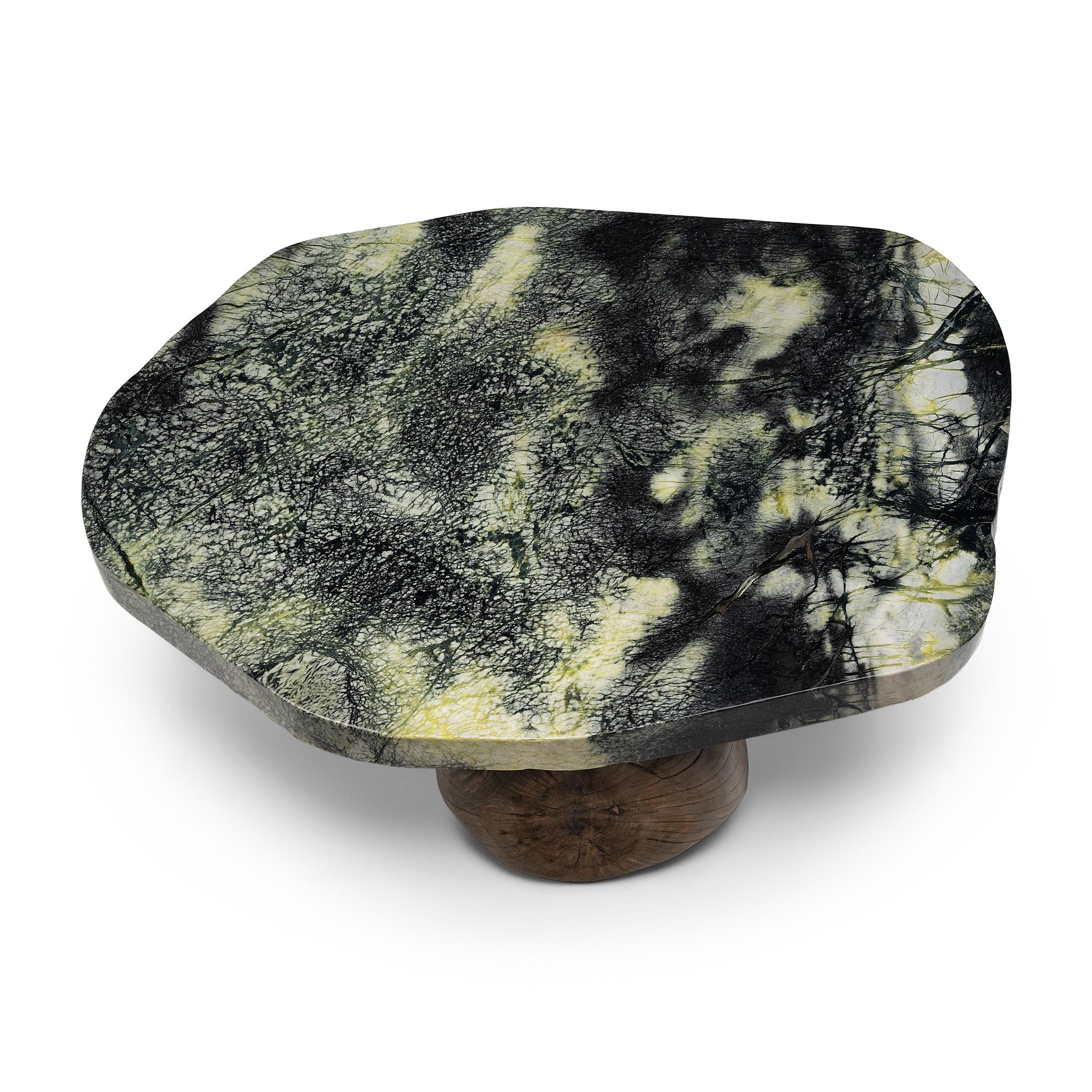 This meditation stone coffee table exemplifies Organic Modern style with an emphasis on natural materials. A polished stone slab comprises the tabletop, awash with lush green color and beautifully patterned with inclusions of serpentine, jadeite and