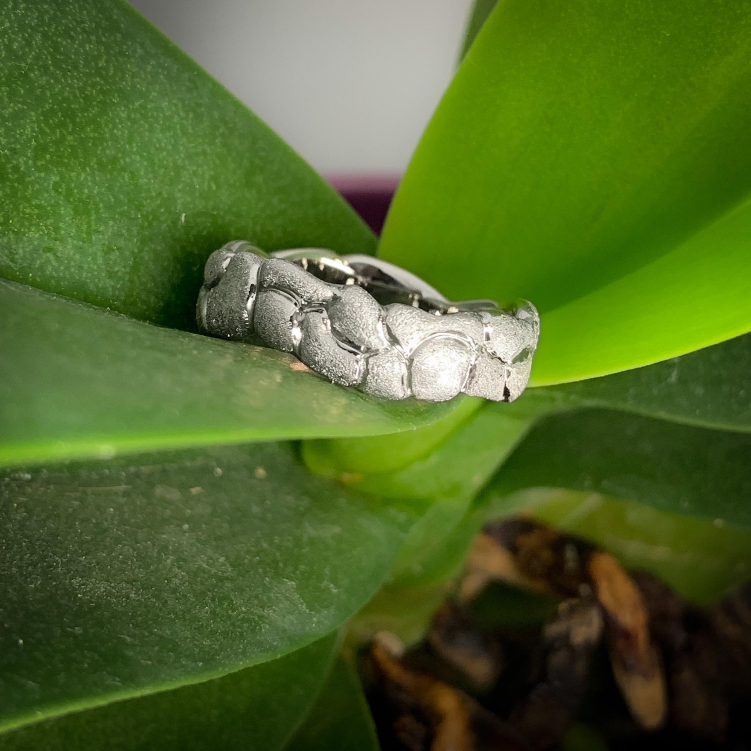 The mossy texture covering this meandering, 18k white gold band sparkles slightly in the light.  Inspired by the low moss-covered rock walls of Massachusetts where Mary's daughter Rose is attending college, this ring is simple, elegant, and wearable