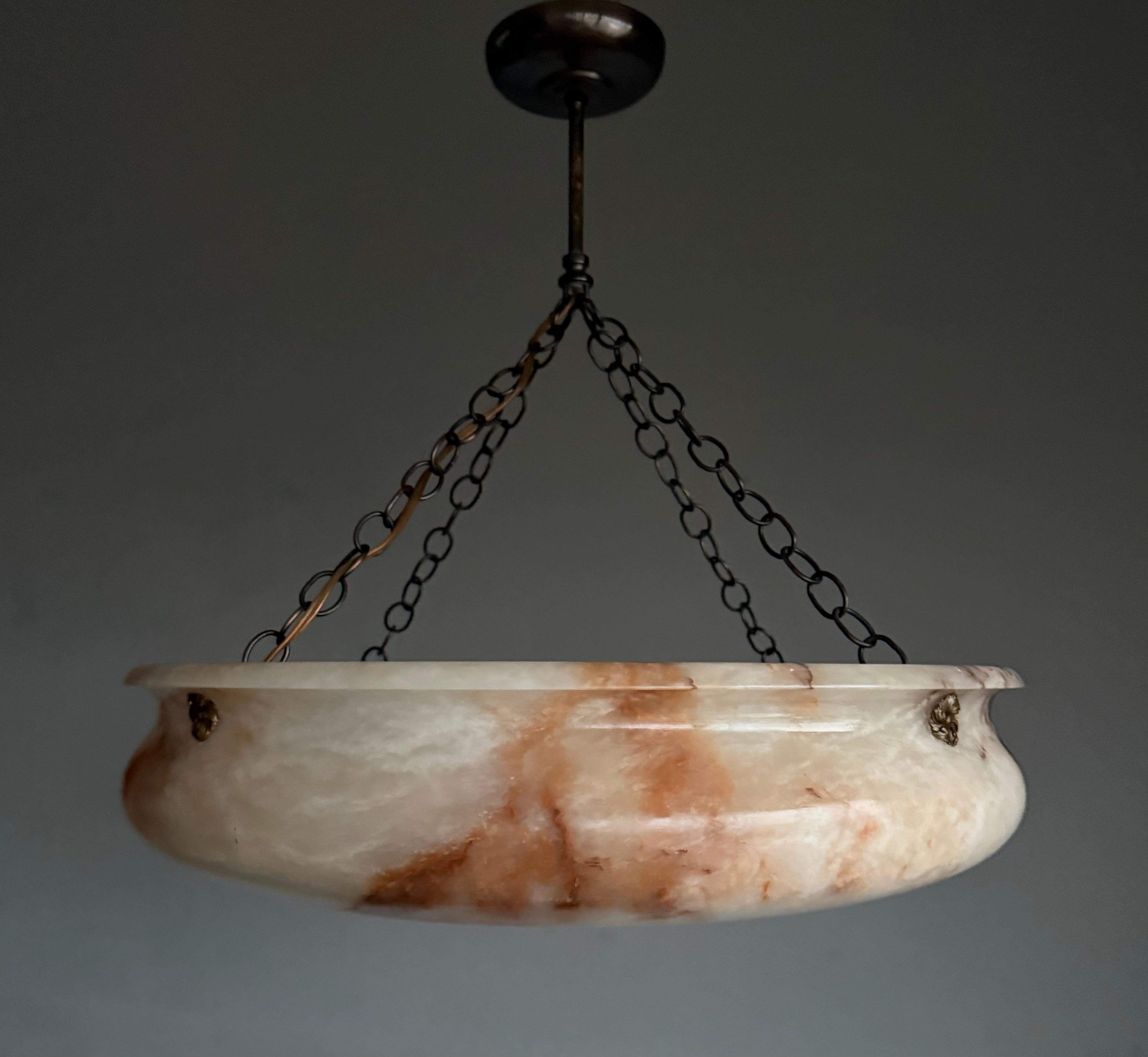 Timeless antique extra large pendant light with a stunning alabaster shade.

Thanks to its timeless design, its extra large size and its mint condition this four light alabaster fixture will light up both your days and evenings, both in summer and